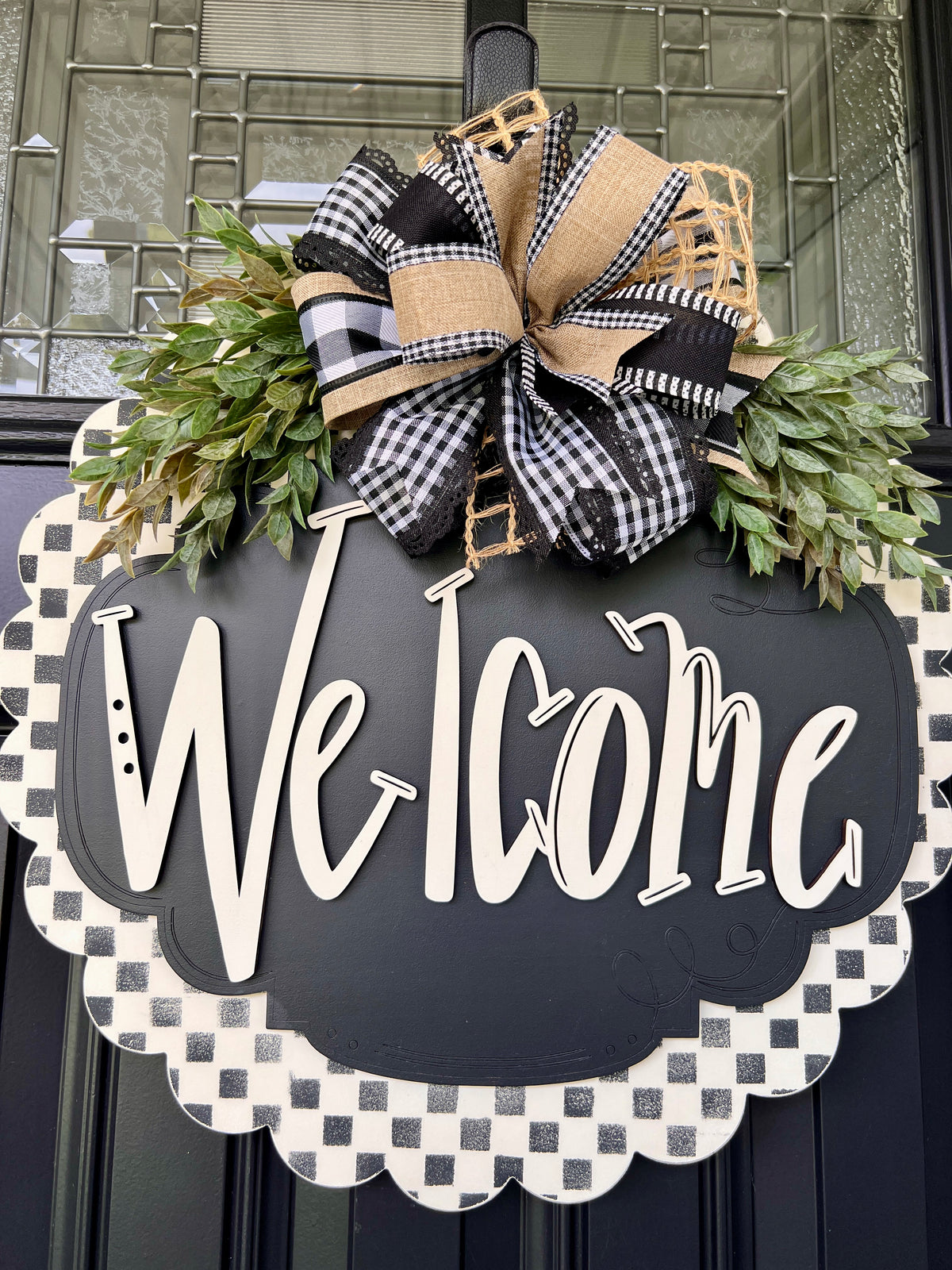 Farmhouse black and white welcome door hanger with eucalyptus greenery and layered ribbon bow