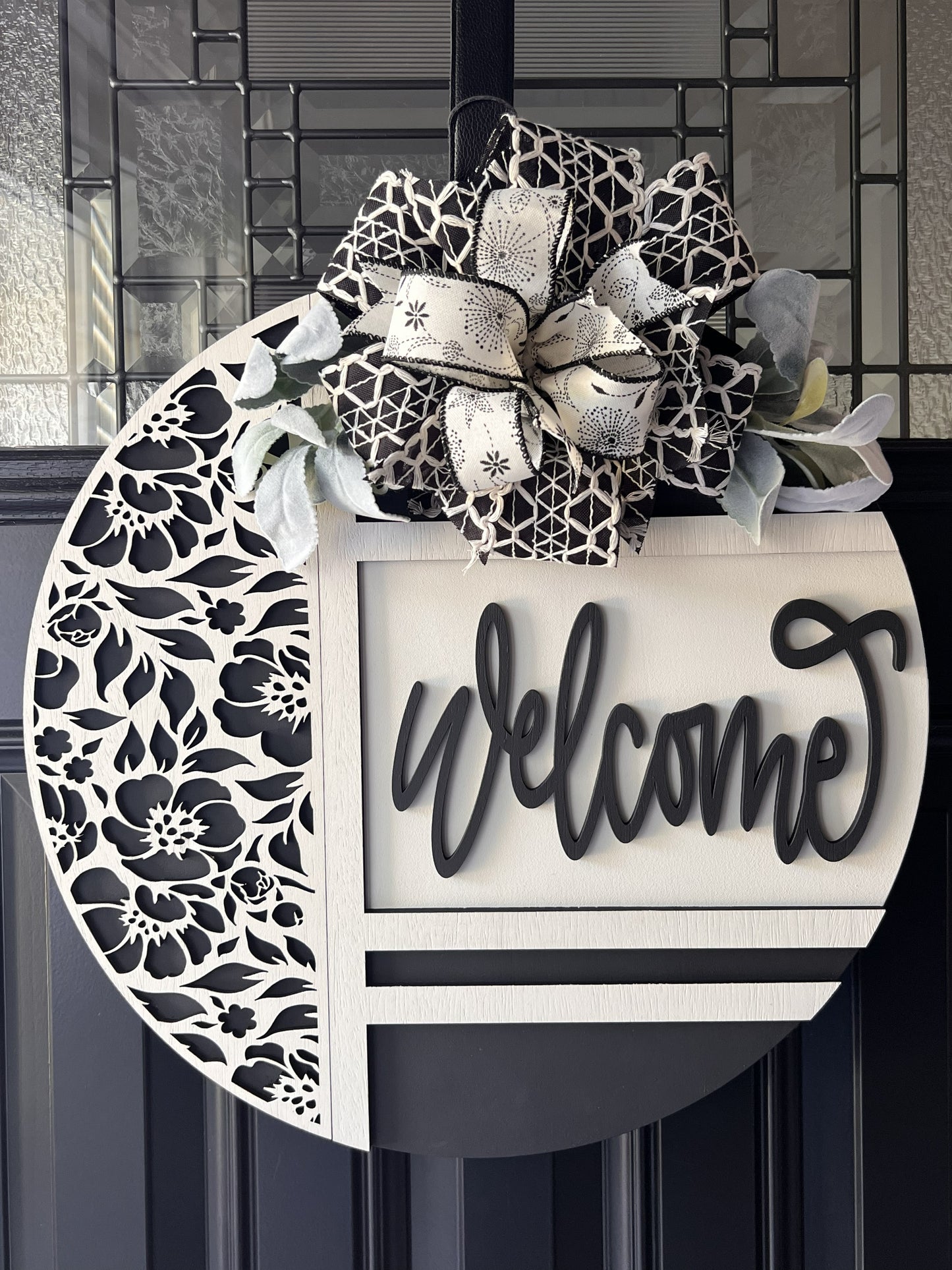 Decorative wreath with floral patterns, elegant entryway decor, black and white round door hanger