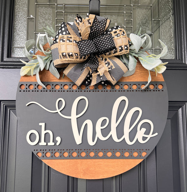 Oh hello door hanger close up showing 3D cream oh hello lettering and upper laser-cut rattan dot border band detail