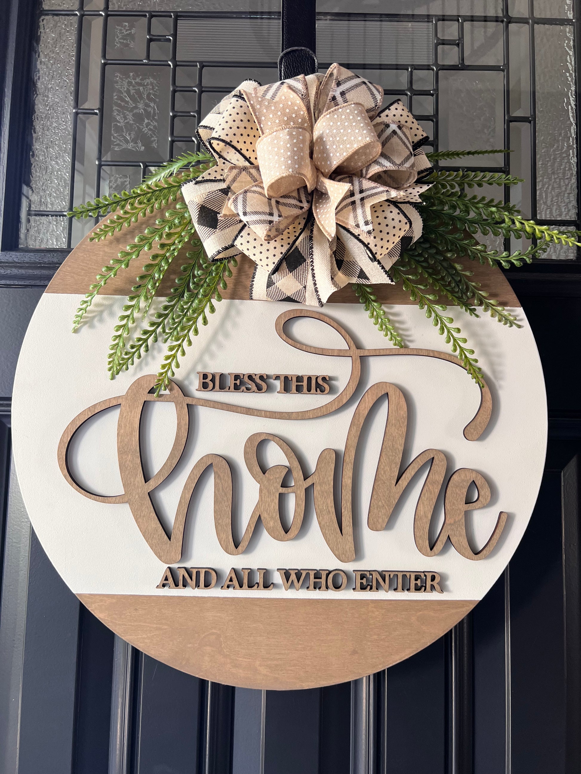 Decorative sign with 'Bless This Home' text and a bow on a door.