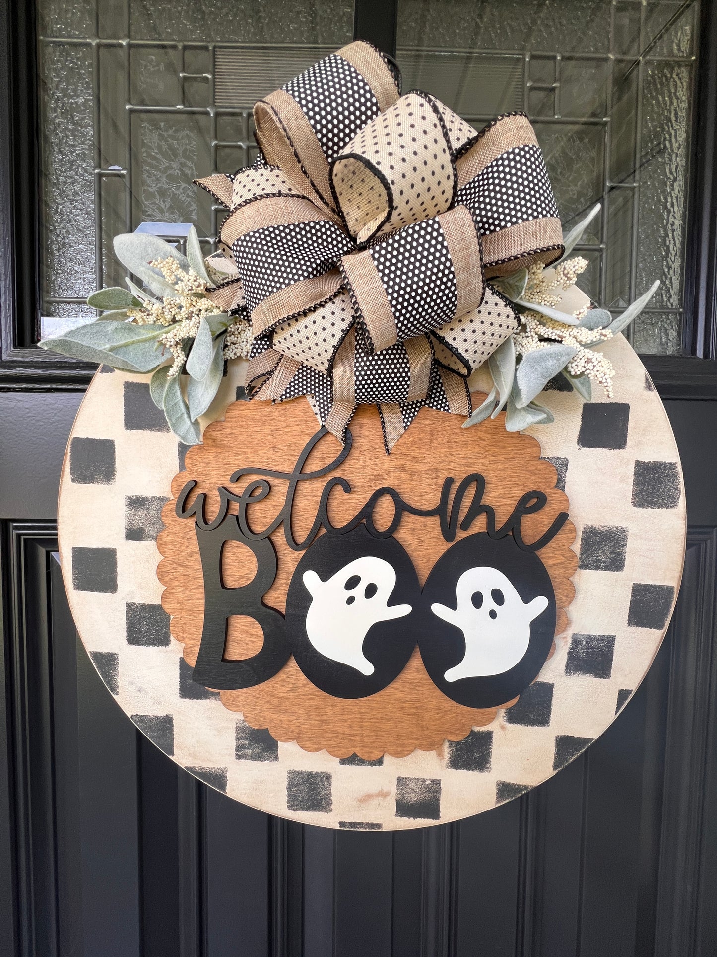 Handmade Welcome Boo Halloween door hanger with ghost accents, black and cream checkered background, layered wood lettering, designer bow, and fall front porch décor.
