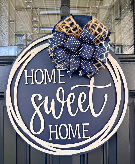 Home Sweet Home navy blue circle framed door hanger on black front door with layered navy polka dot grid and jute burlap bow
