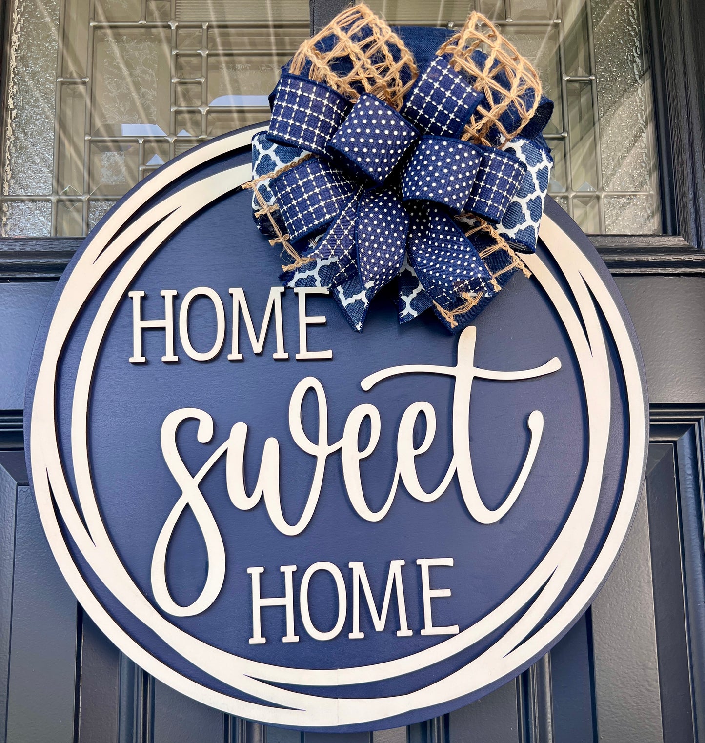 Home Sweet Home navy door hanger close up showing full bow detail with navy polka dot grid quatrefoil and natural jute ribbons