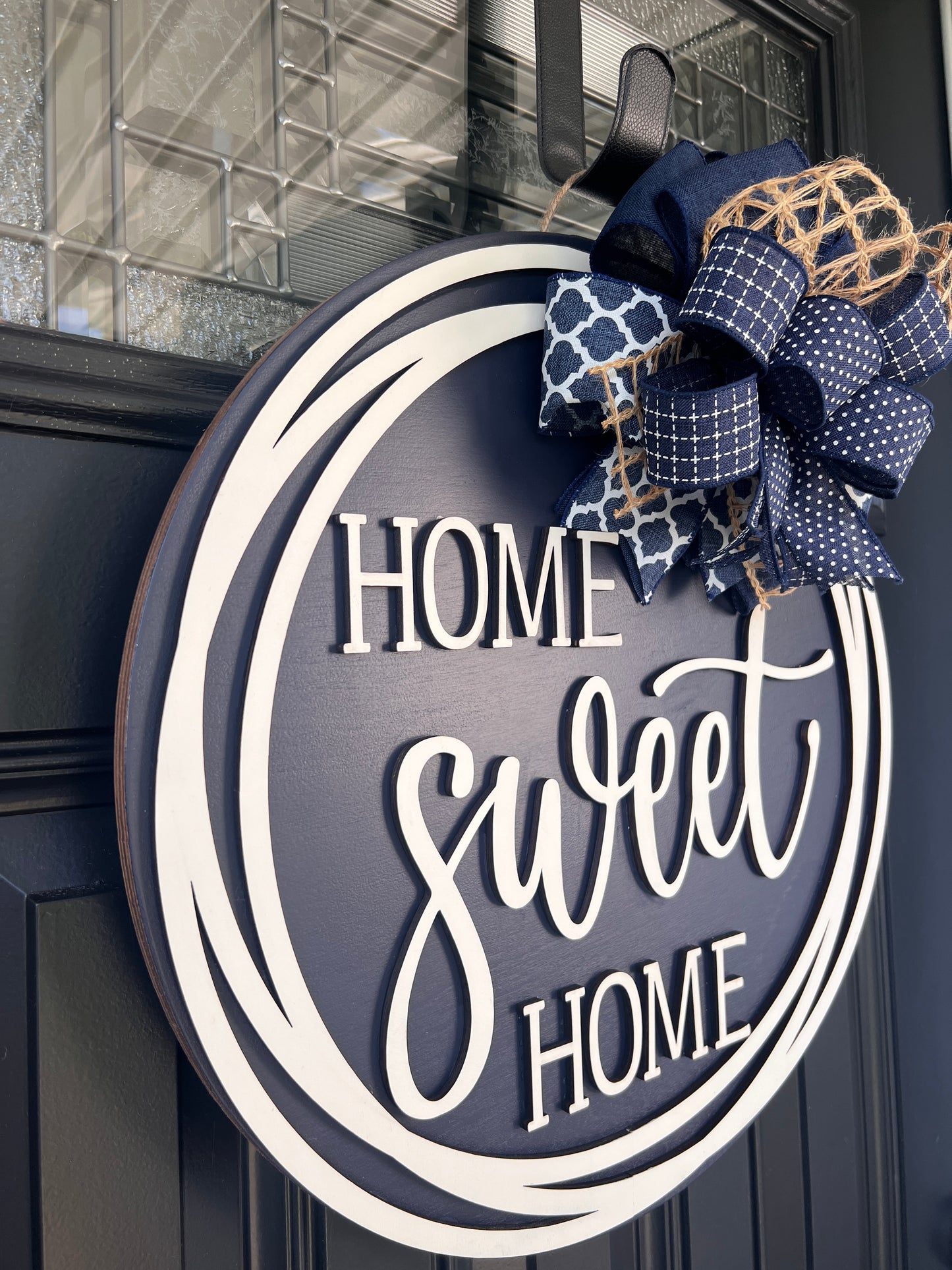 Home Sweet Home navy door hanger angled side view showing depth of 3D cream lettering and cream double circle frame