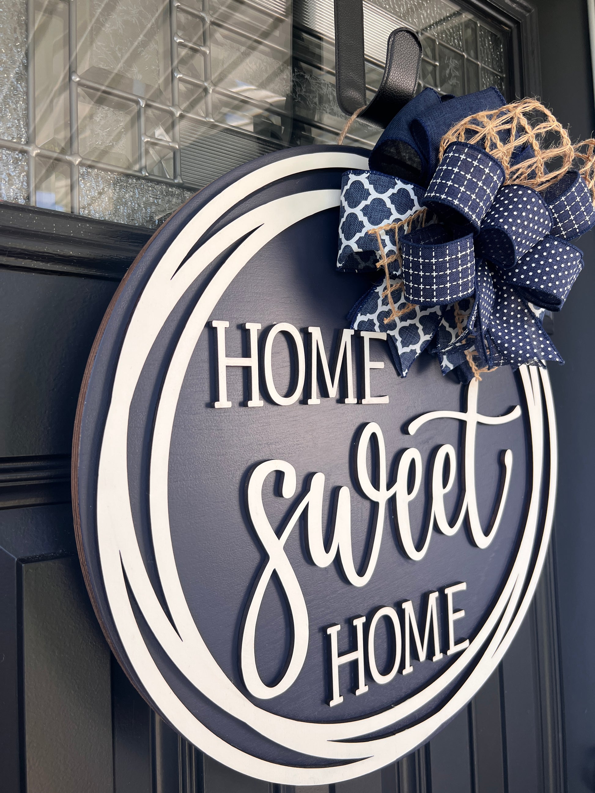 Home Sweet Home navy door hanger angled side view showing depth of 3D cream lettering and cream double circle frame
