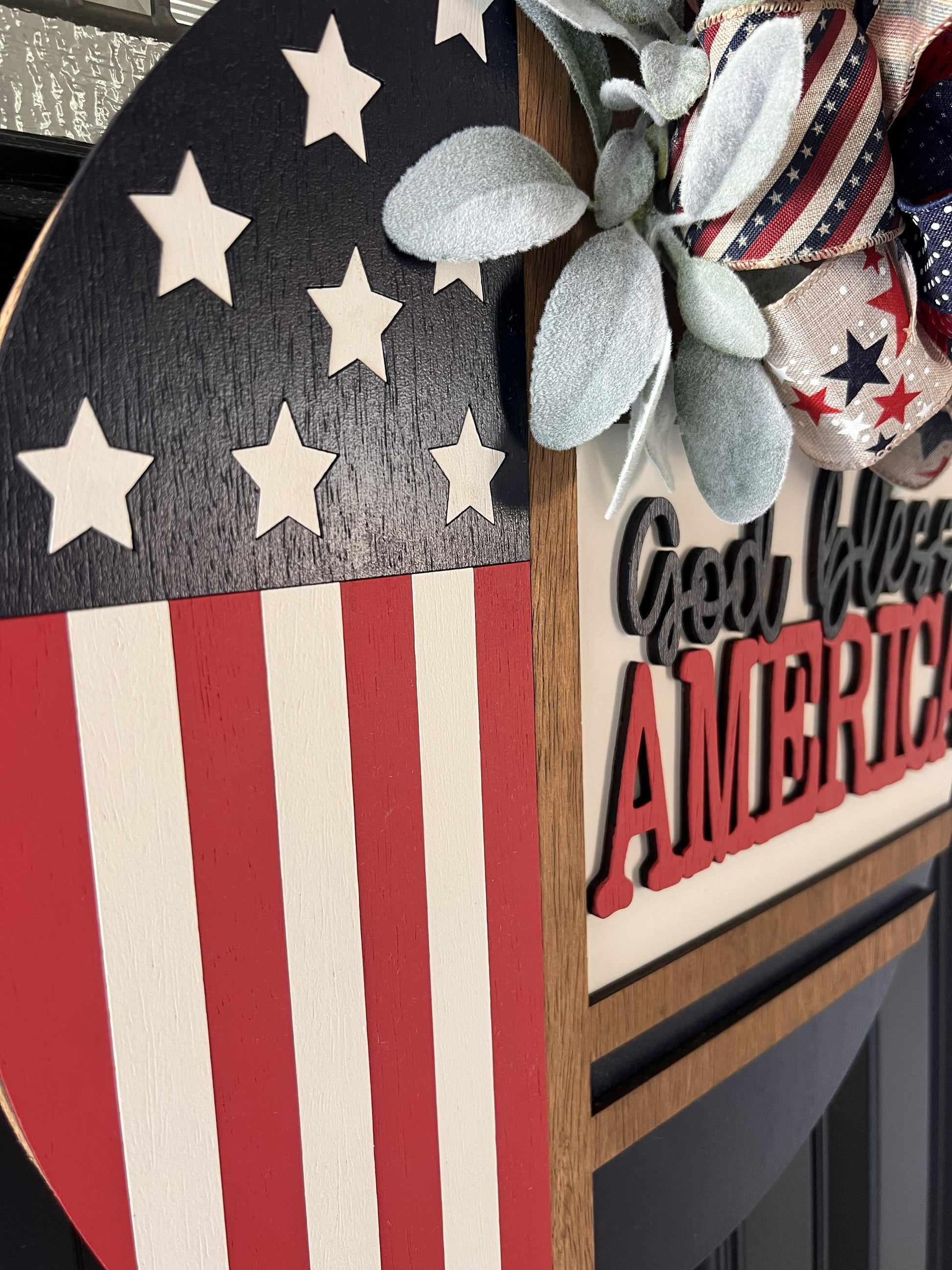 Decorative sign with American flag design and 'God Bless America' text.
