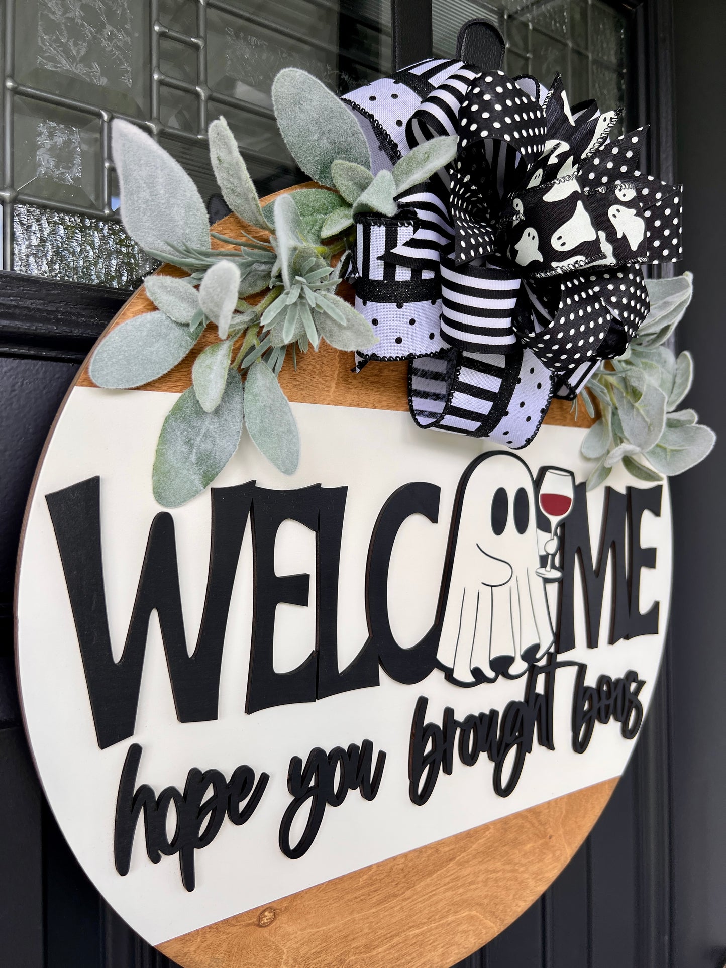 Welcome Hope You Brought Boos door hanger close up showing 3D lettering and ghost holding red wine glass