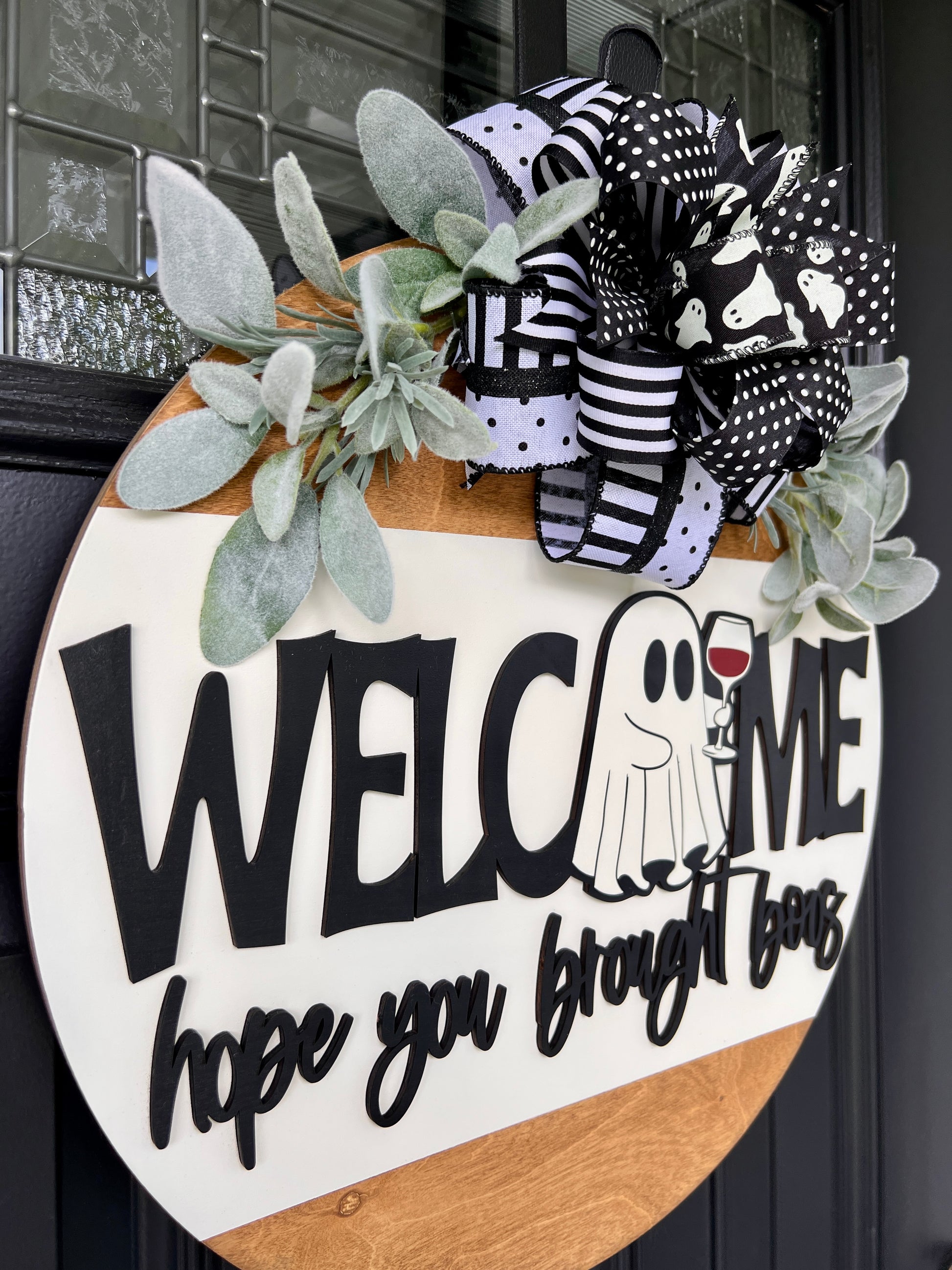 Welcome Hope You Brought Boos door hanger close up showing 3D lettering and ghost holding red wine glass
