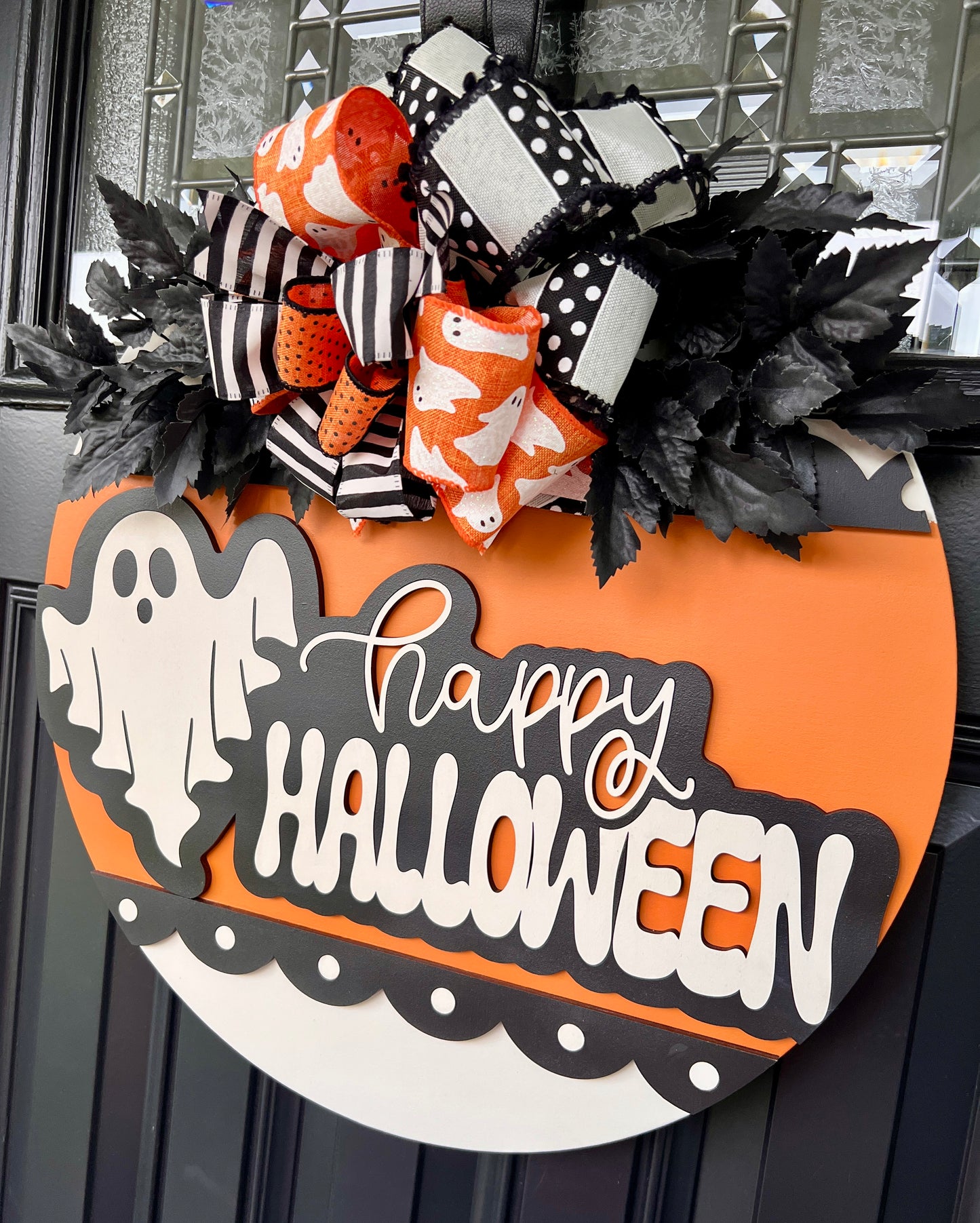 Happy Halloween ghost sign close up of bow with black white stripe orange ghost print and polka dot ribbons