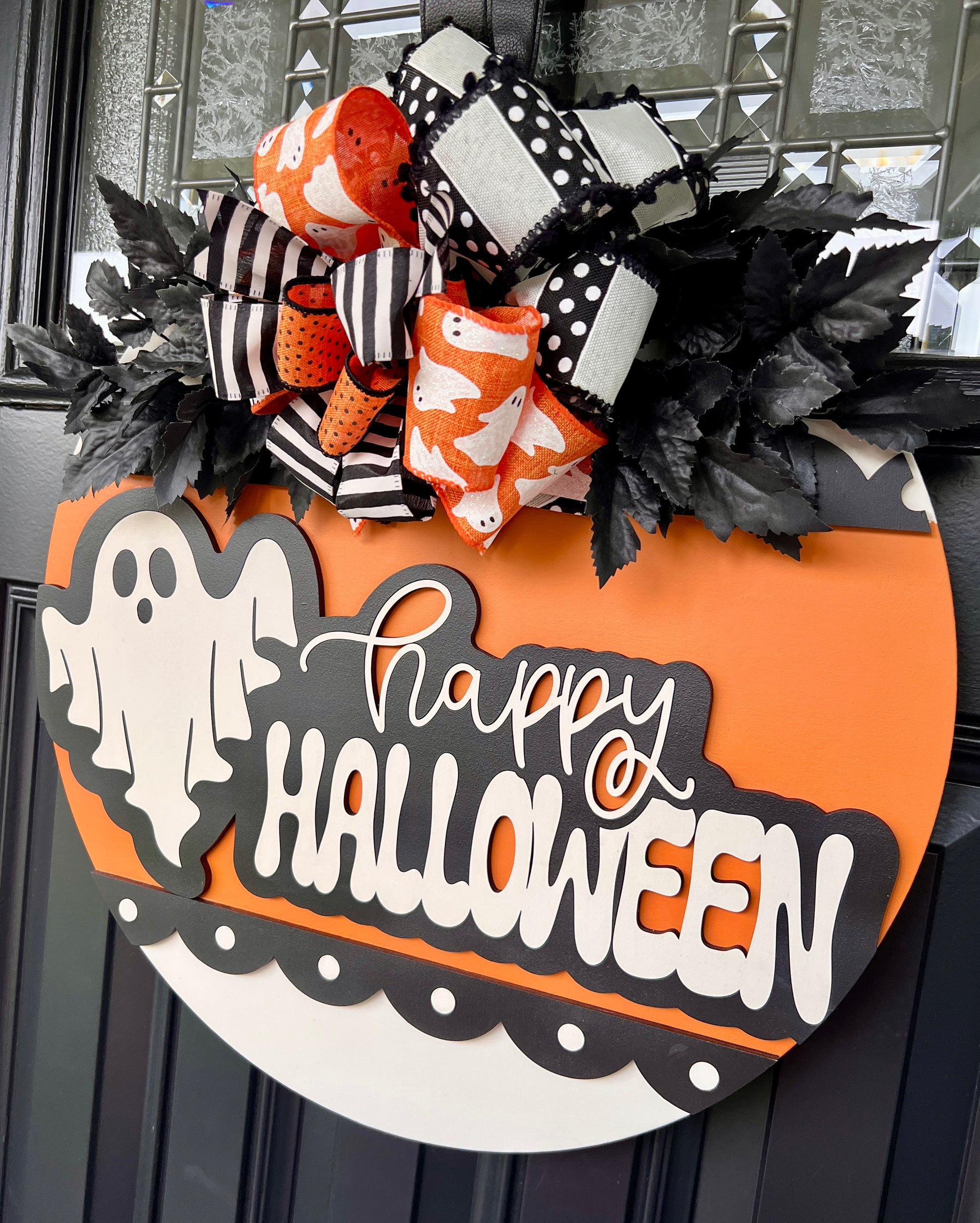Happy Halloween ghost sign close up of bow with black white stripe orange ghost print and polka dot ribbons