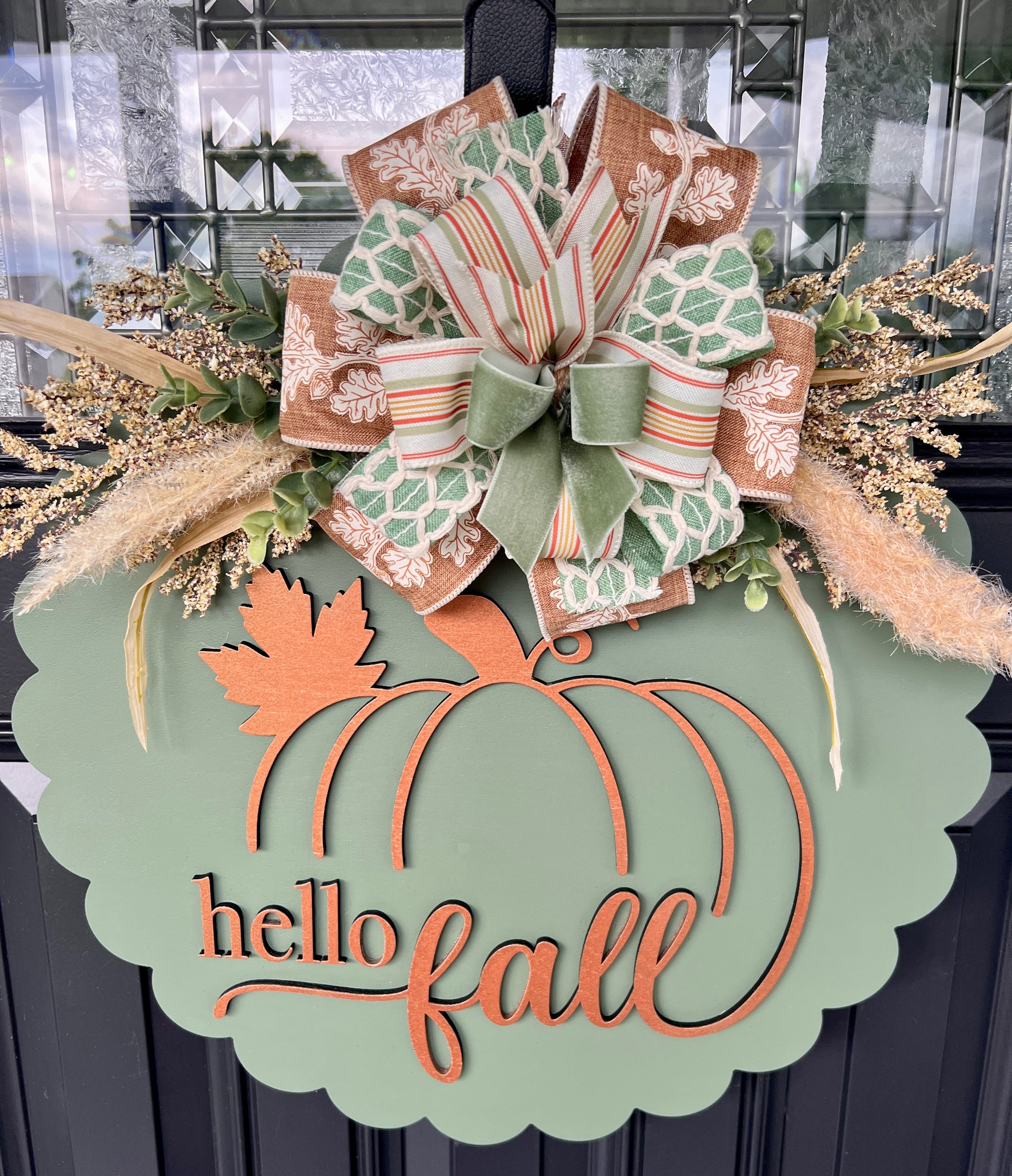 Side angle view of hello fall door hanger showing scalloped birch wood edge and ribbon bow detail