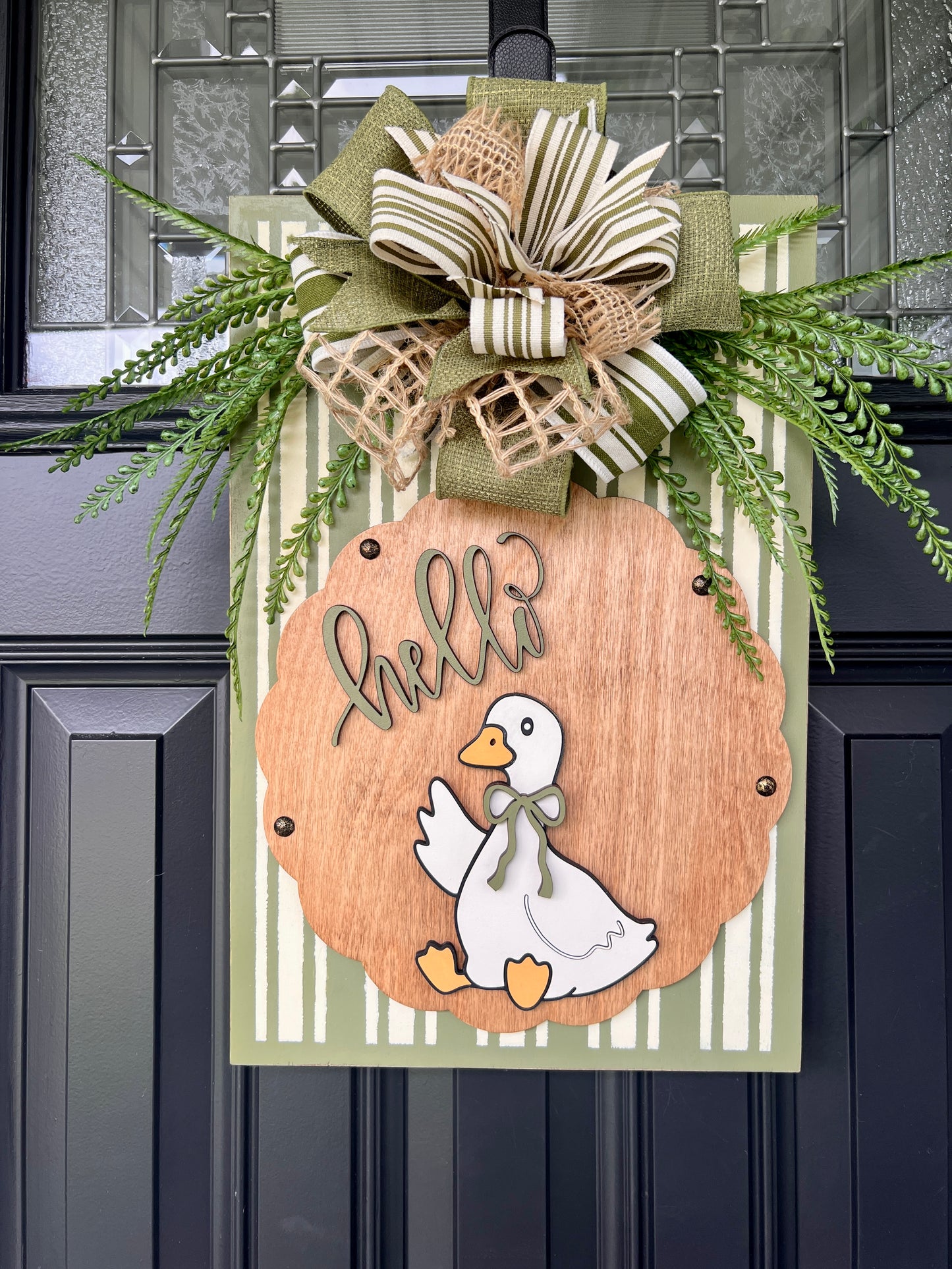 Hello Goose sign full front view showing complete design with bow and cascading fern greenery on black door