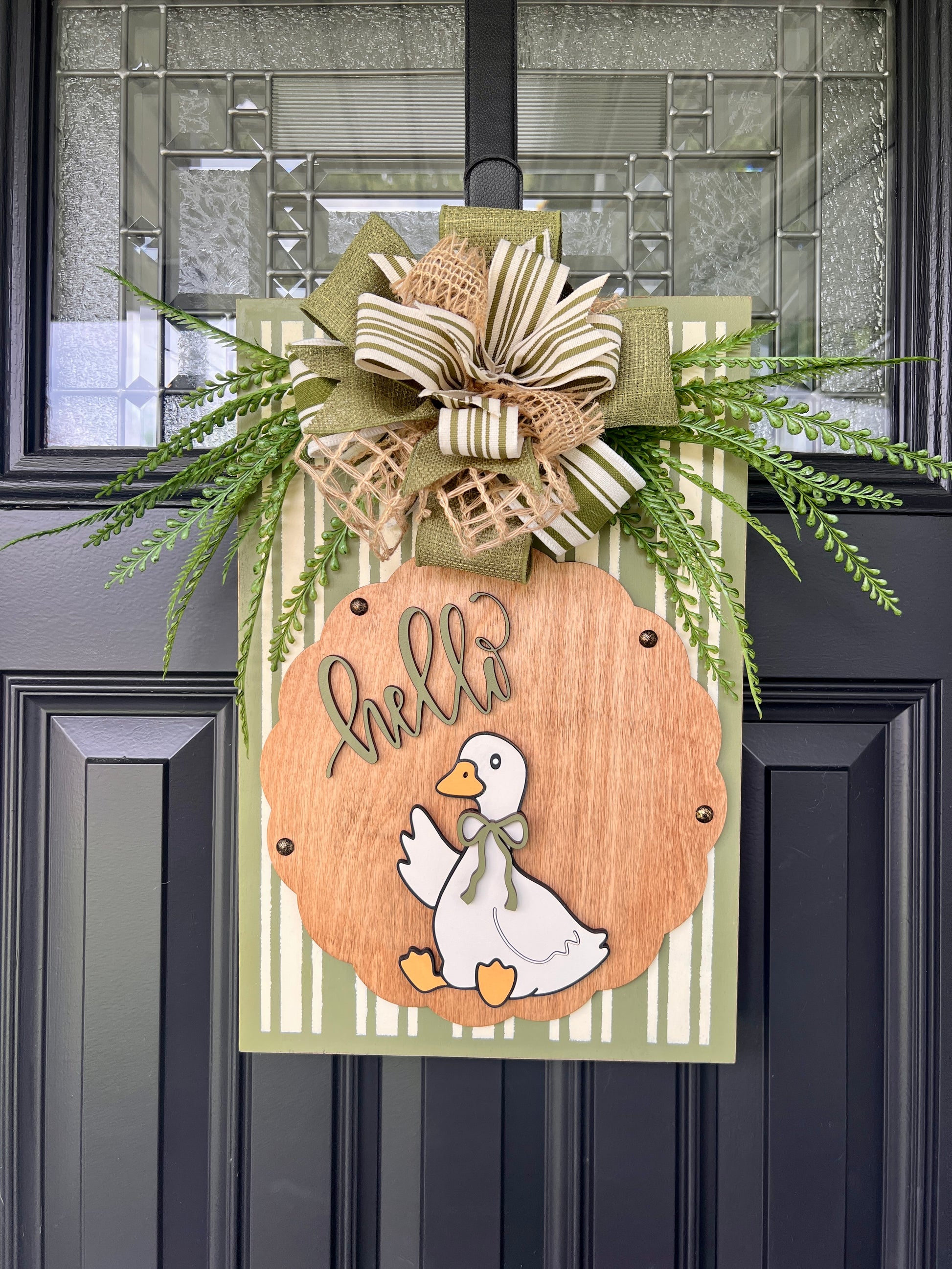 Hello Goose olive green door sign close up of layered bow with olive mesh burlap and cream stripe ribbons
