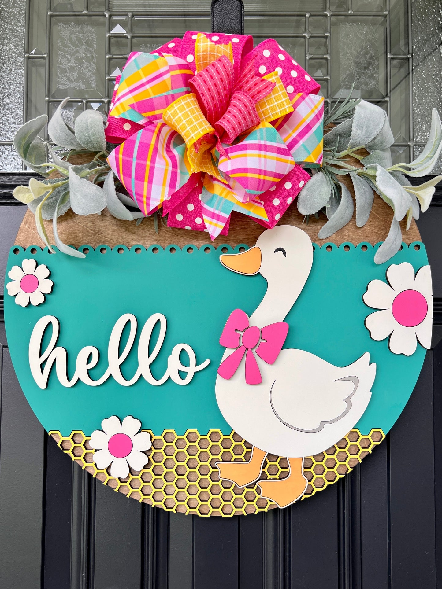 Hello Goose teal door hanger full front view on black door