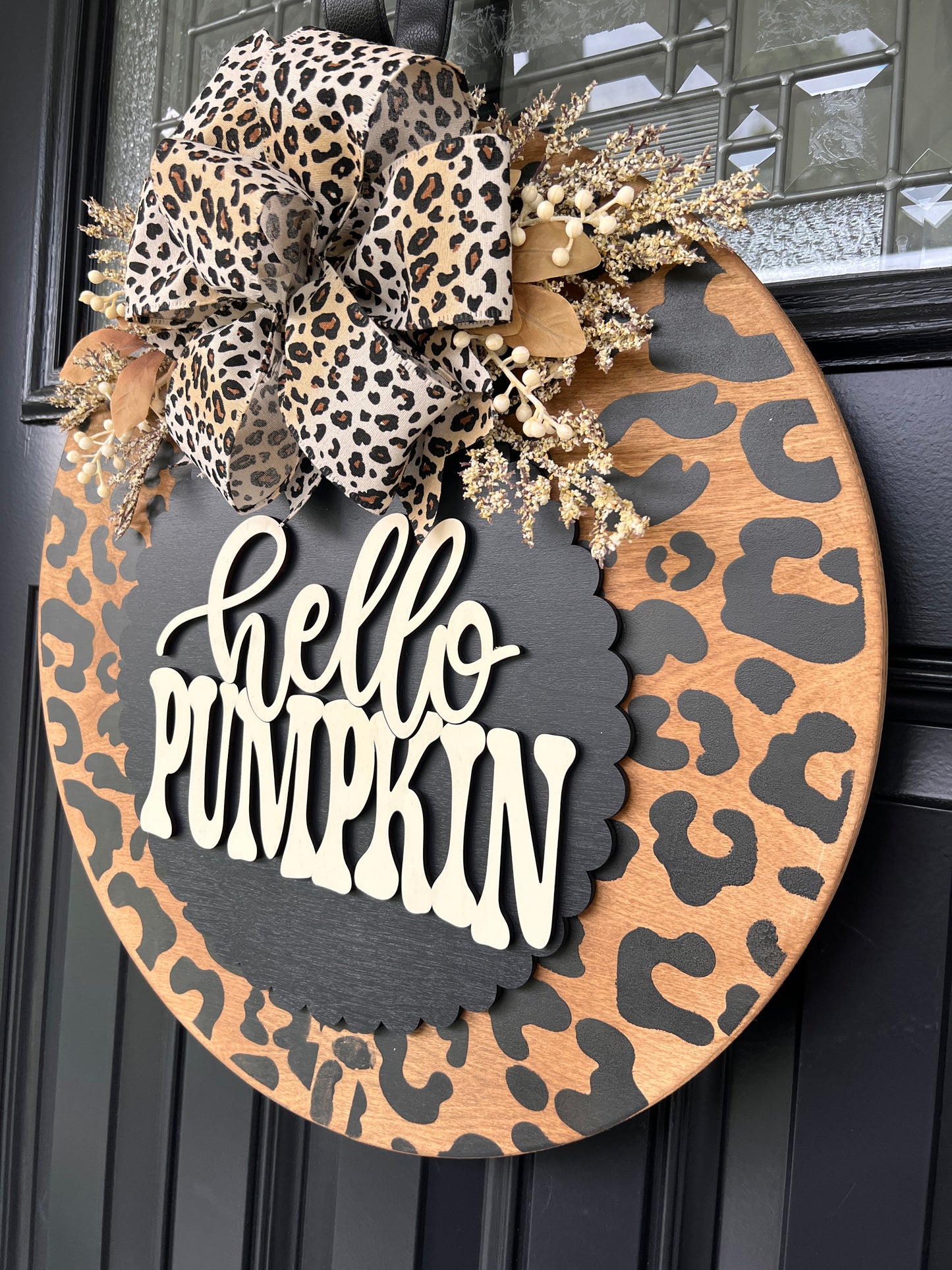 Hello Pumpkin leopard door hanger close up showing 3D cream lettering on charcoal scalloped panel