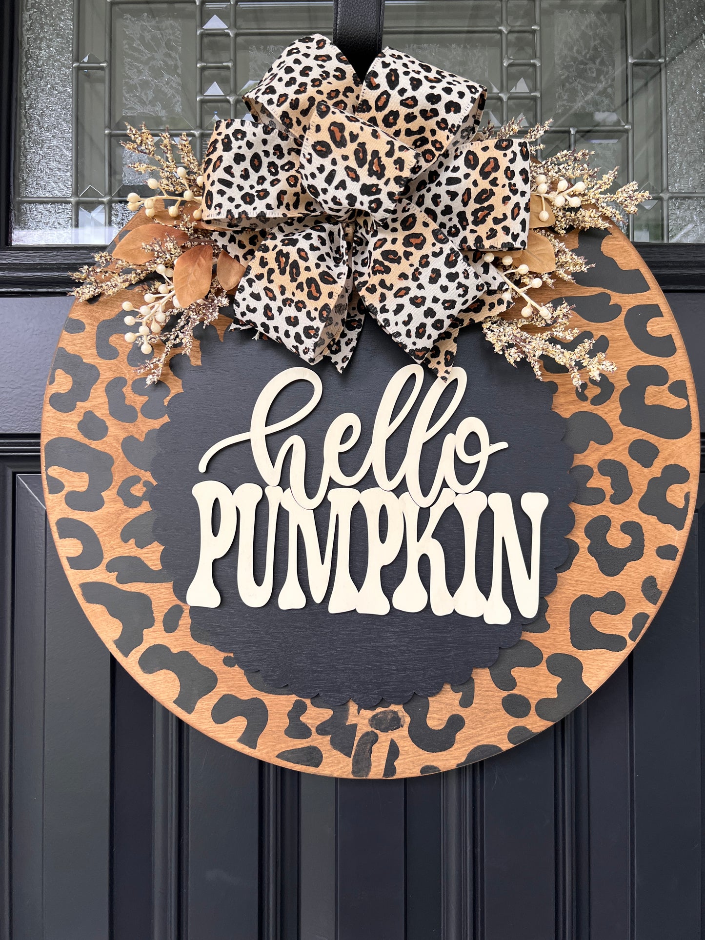 Hello Pumpkin leopard print birchwood door hanger full view on black front door