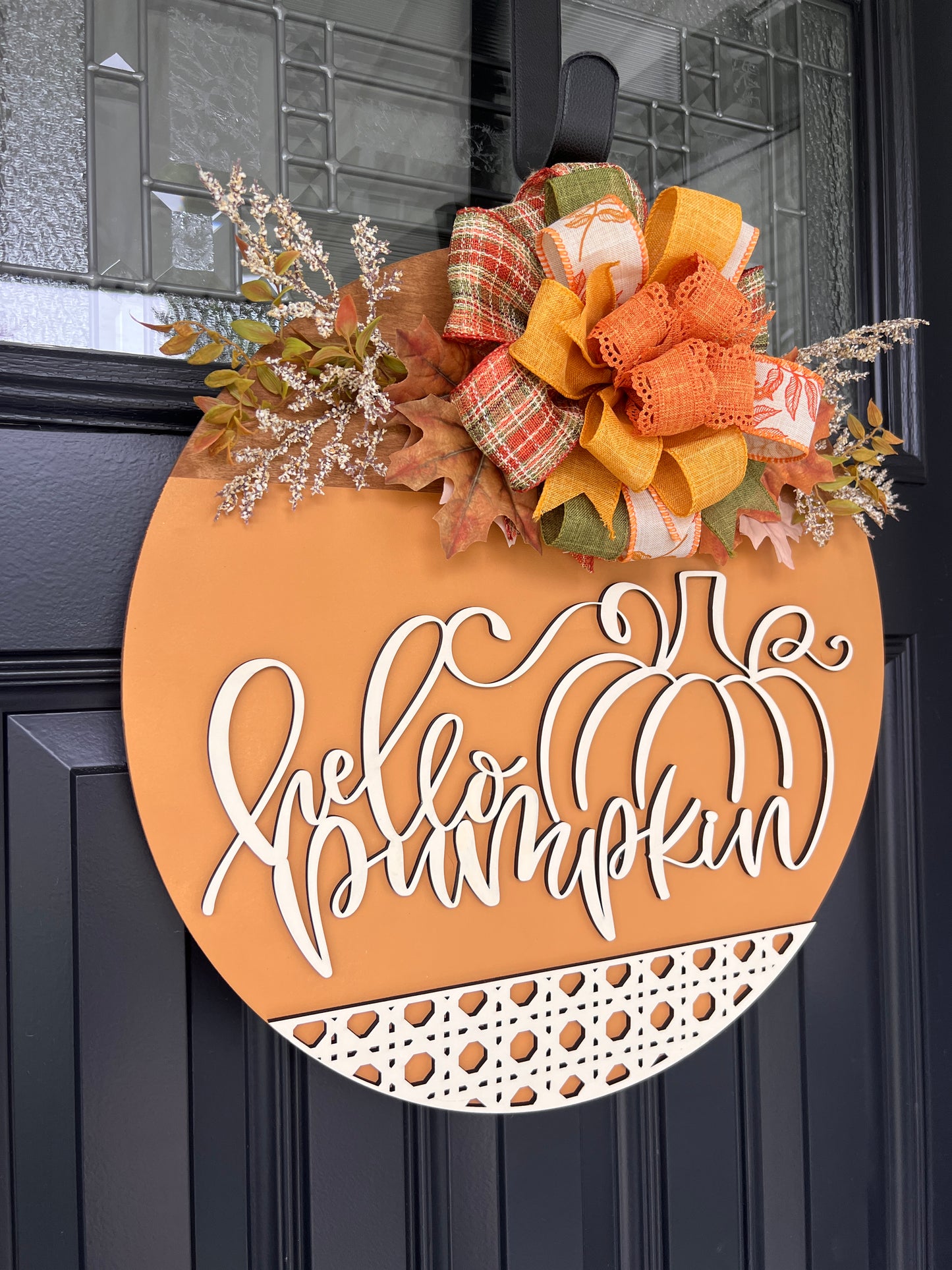 Hello Pumpkin door hanger close up showing bow detail with fall leaves and white florals