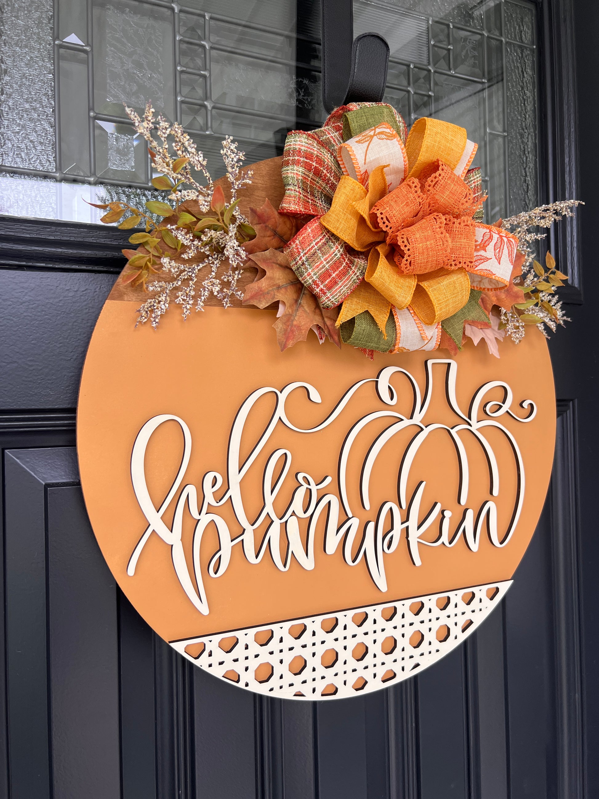 Hello Pumpkin door hanger close up showing bow detail with fall leaves and white florals