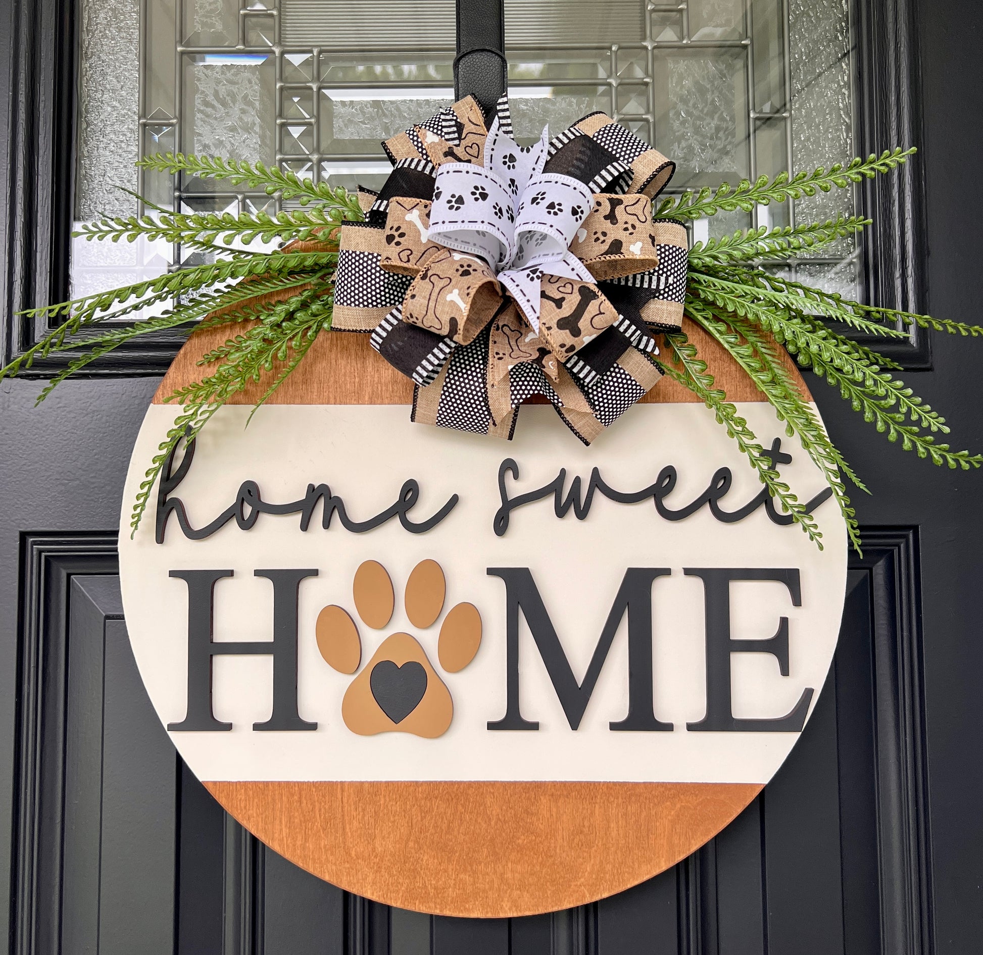 Home Sweet Home dog paw door hanger full view with fern greenery and layered bow on front door