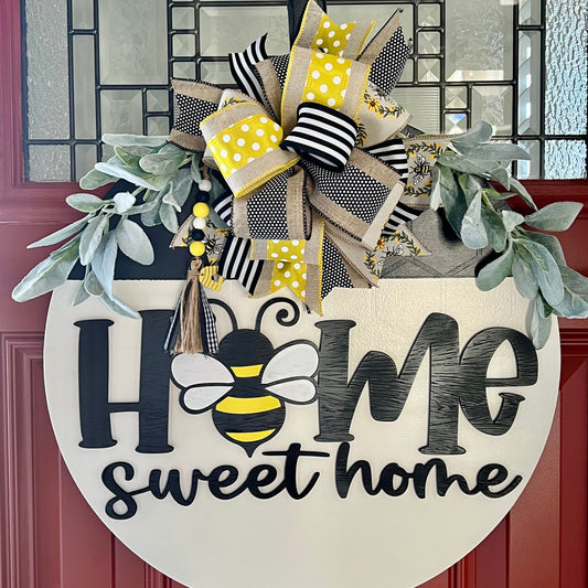 “Home Sweet Home bee spring door hanger with yellow and black bow on a front door”