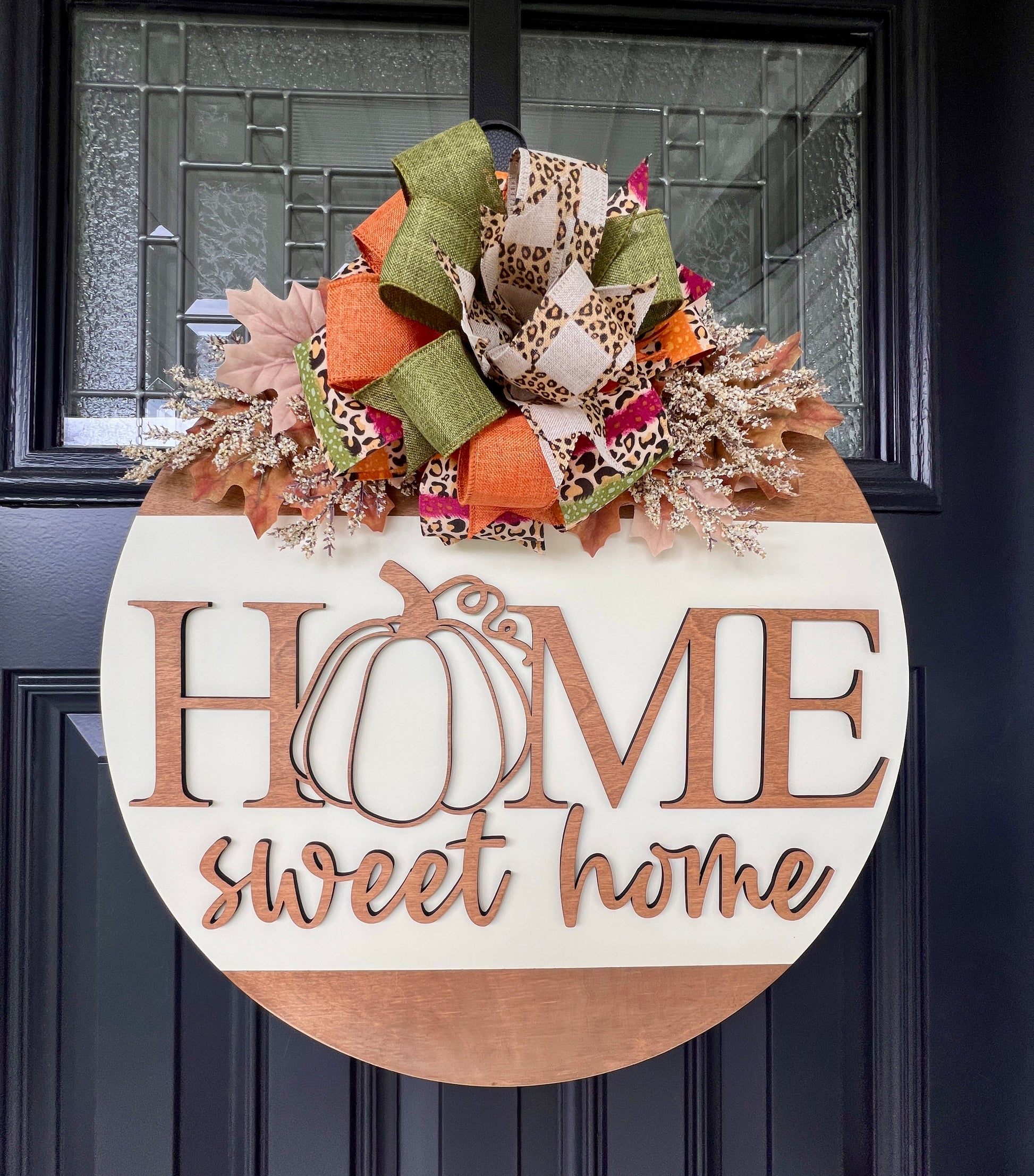 Fall door hanger with 'Home sweet home' and pumpkin design, featuring a Fall bow on Fall florals.