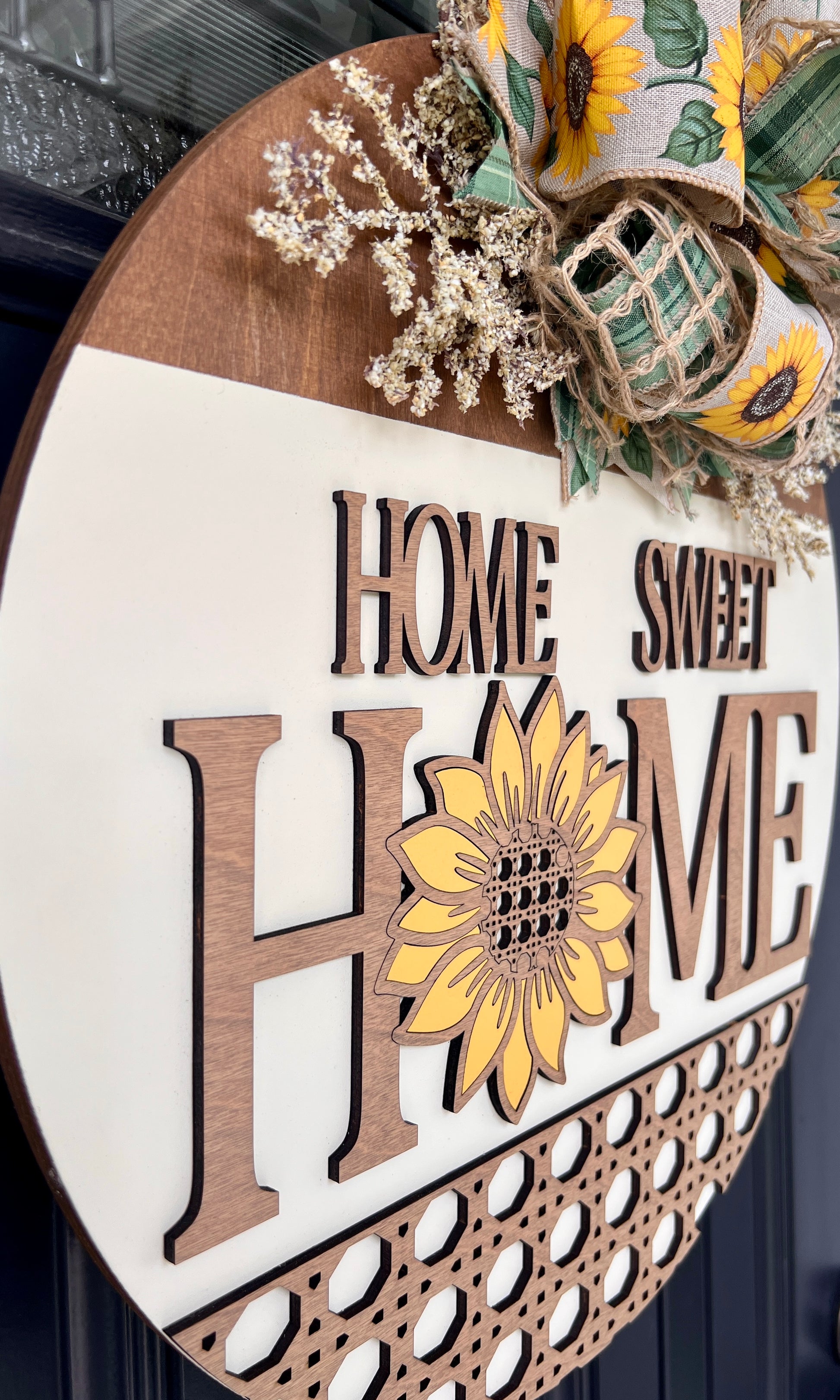 Home Sweet Home sunflower door hanger angled view showing 3D natural wood lettering and hand-painted sunflower on cream panel