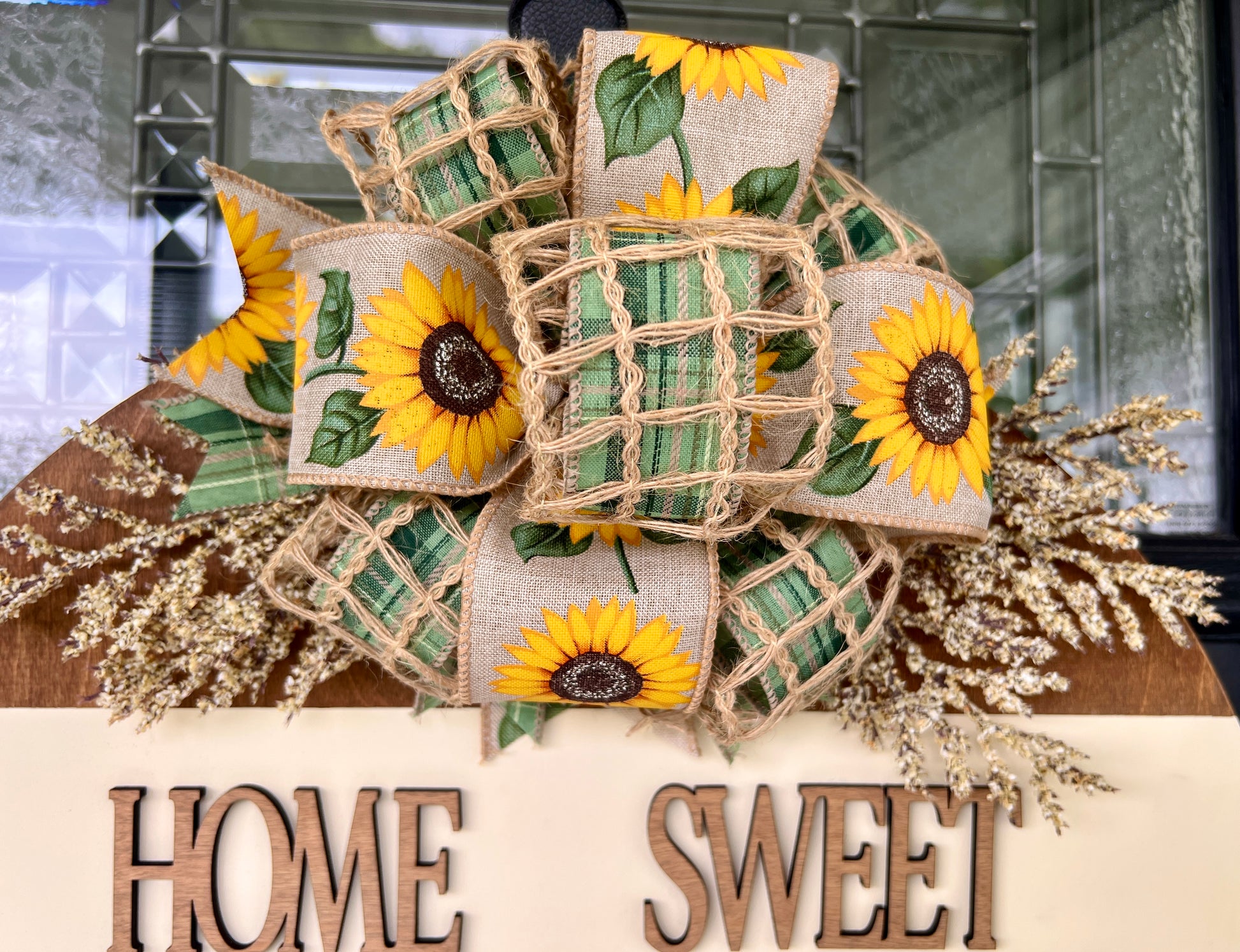 Home Sweet Home sunflower door hanger close up of layered sunflower bow with dried cream floral sprays cascading on both sides