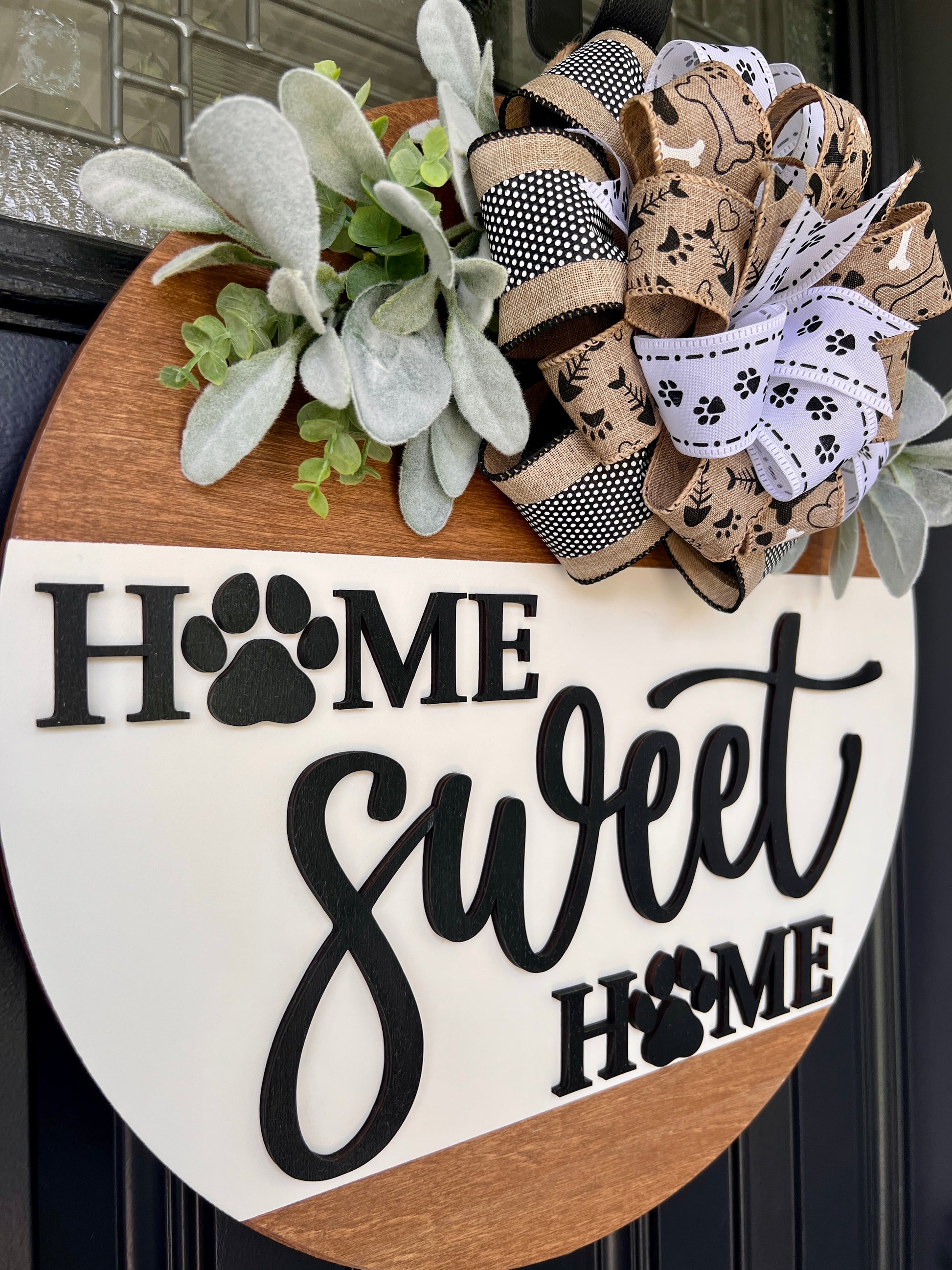 Home Sweet Home paw print door hanger close up showing full lettering detail with both paw print O's and script sweet on cream background