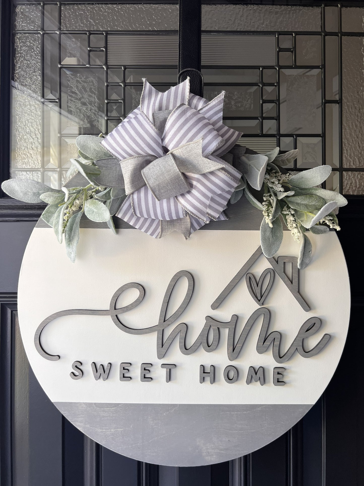 “Home Sweet Home wooden door hanger with neutral tones, layered lettering, bow and greenery on front door" BEST SELLER 