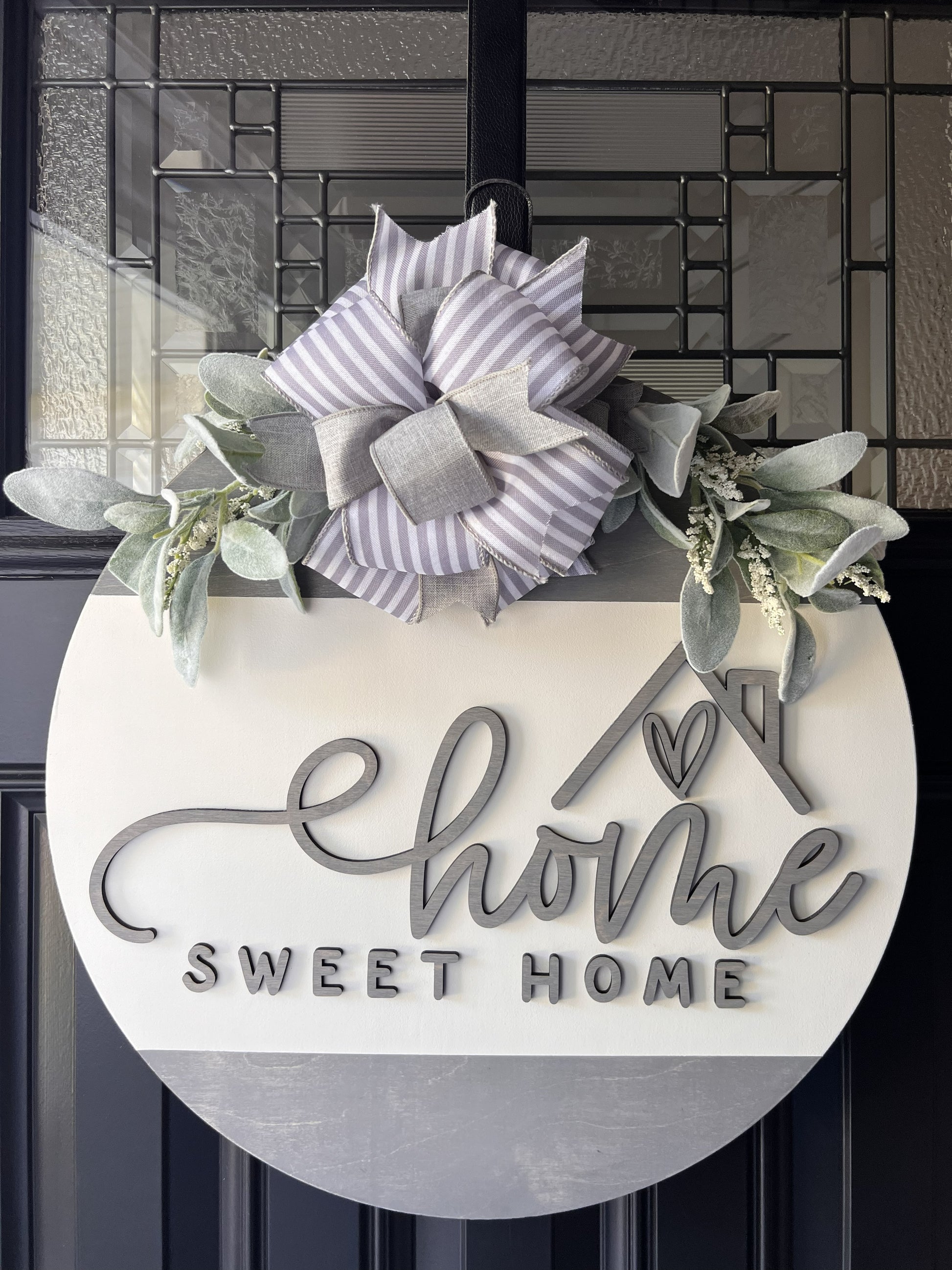 “Home Sweet Home wooden door hanger with neutral tones, layered lettering, bow and greenery on front door" BEST SELLER 