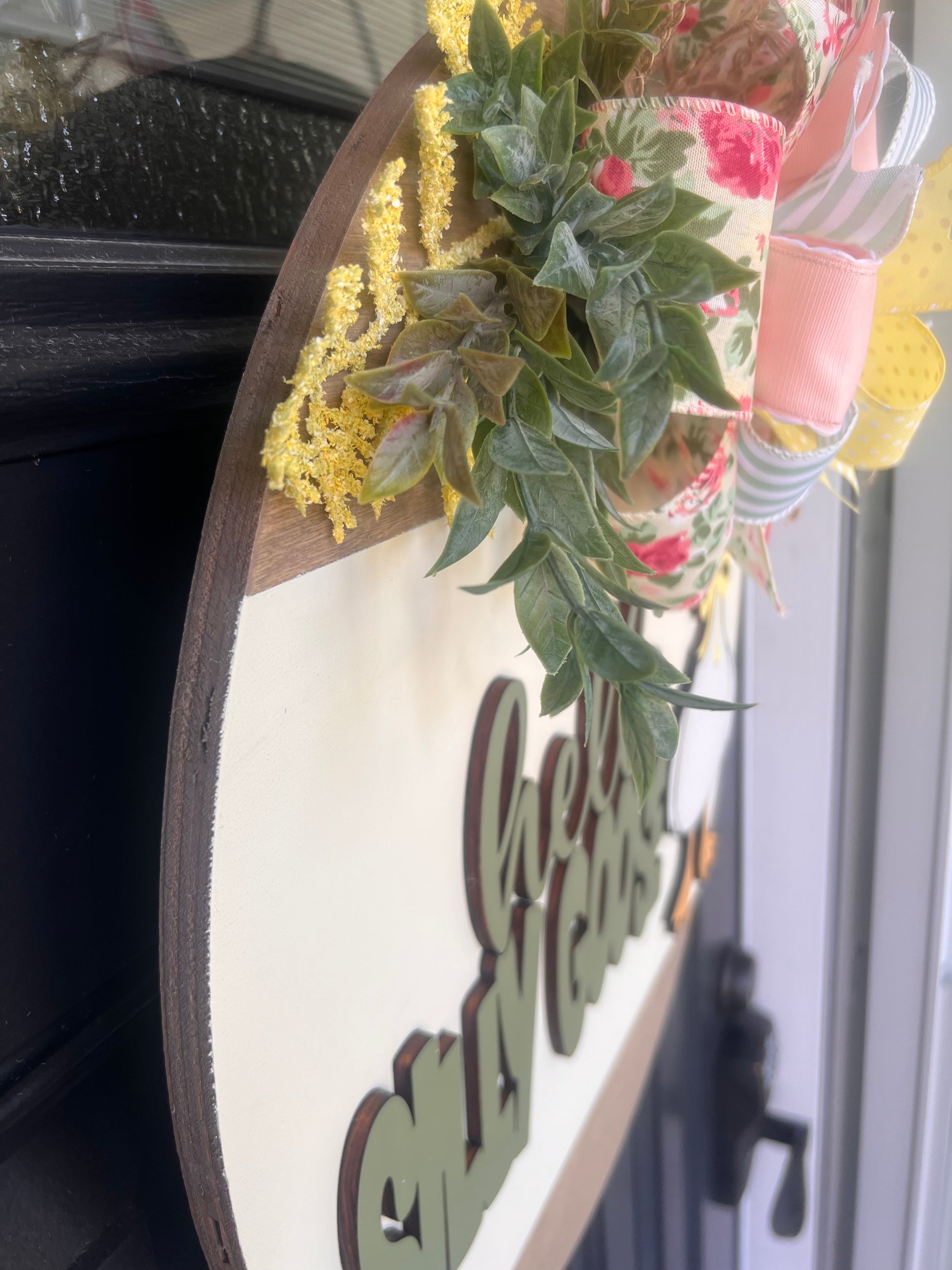 Decorative wreath with flowers and text on a door