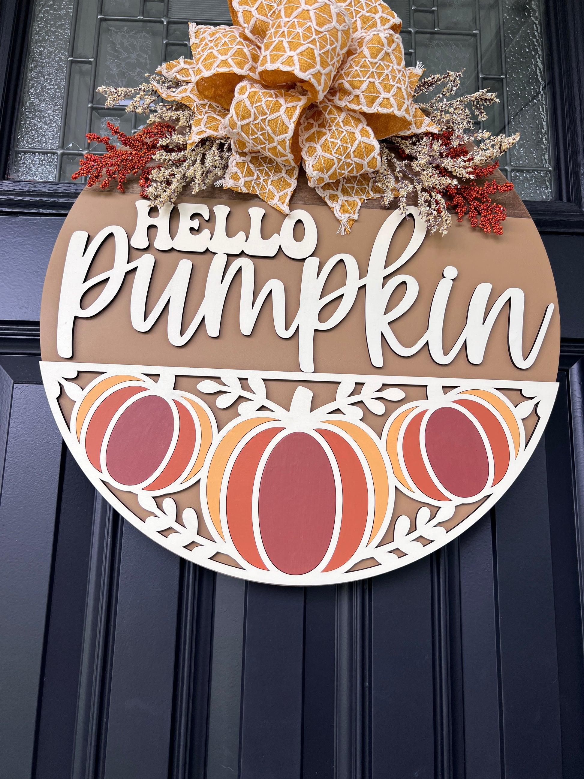 Hello Pumpkin Trio door hanger close up showing laser-cut pumpkin trio panel with rust orange and amber hand-painted pumpkins