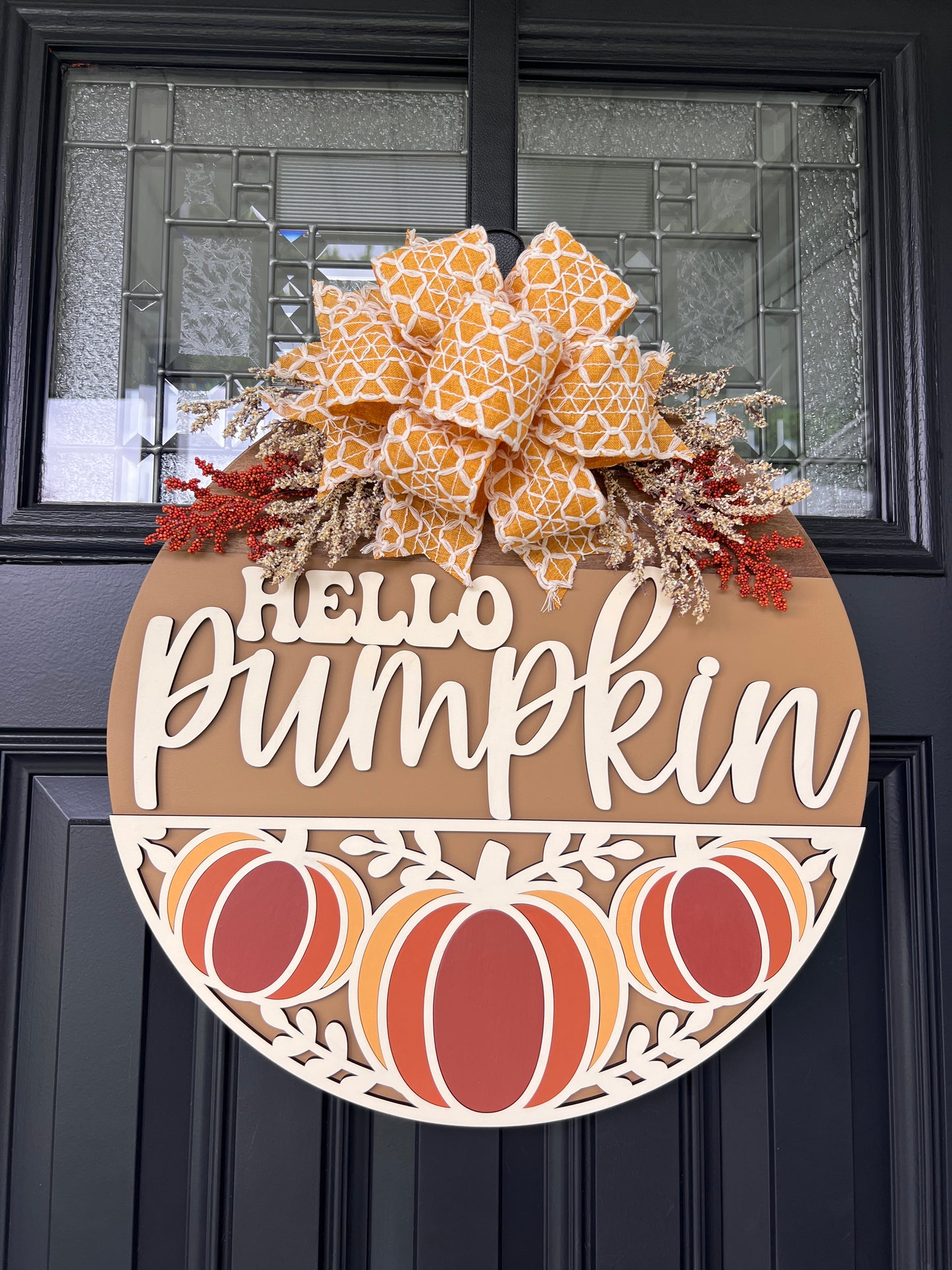 Hello Pumpkin Trio door hanger full front view showing complete 18 inch round with caramel upper panel and cream-framed pumpkin lower panel
