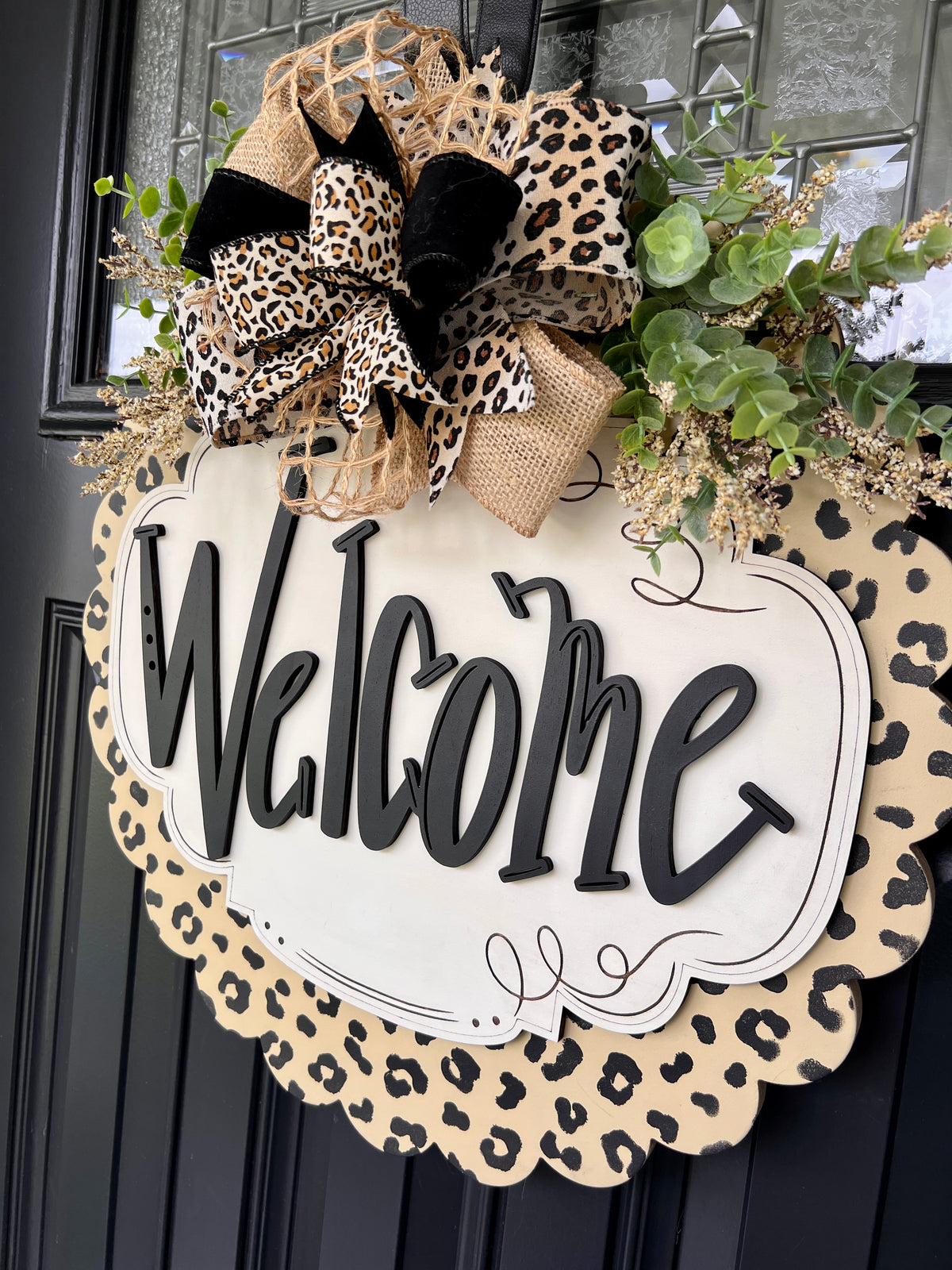 Leopard scalloped Welcome sign showing hand-lettered script and scalloped wood edge