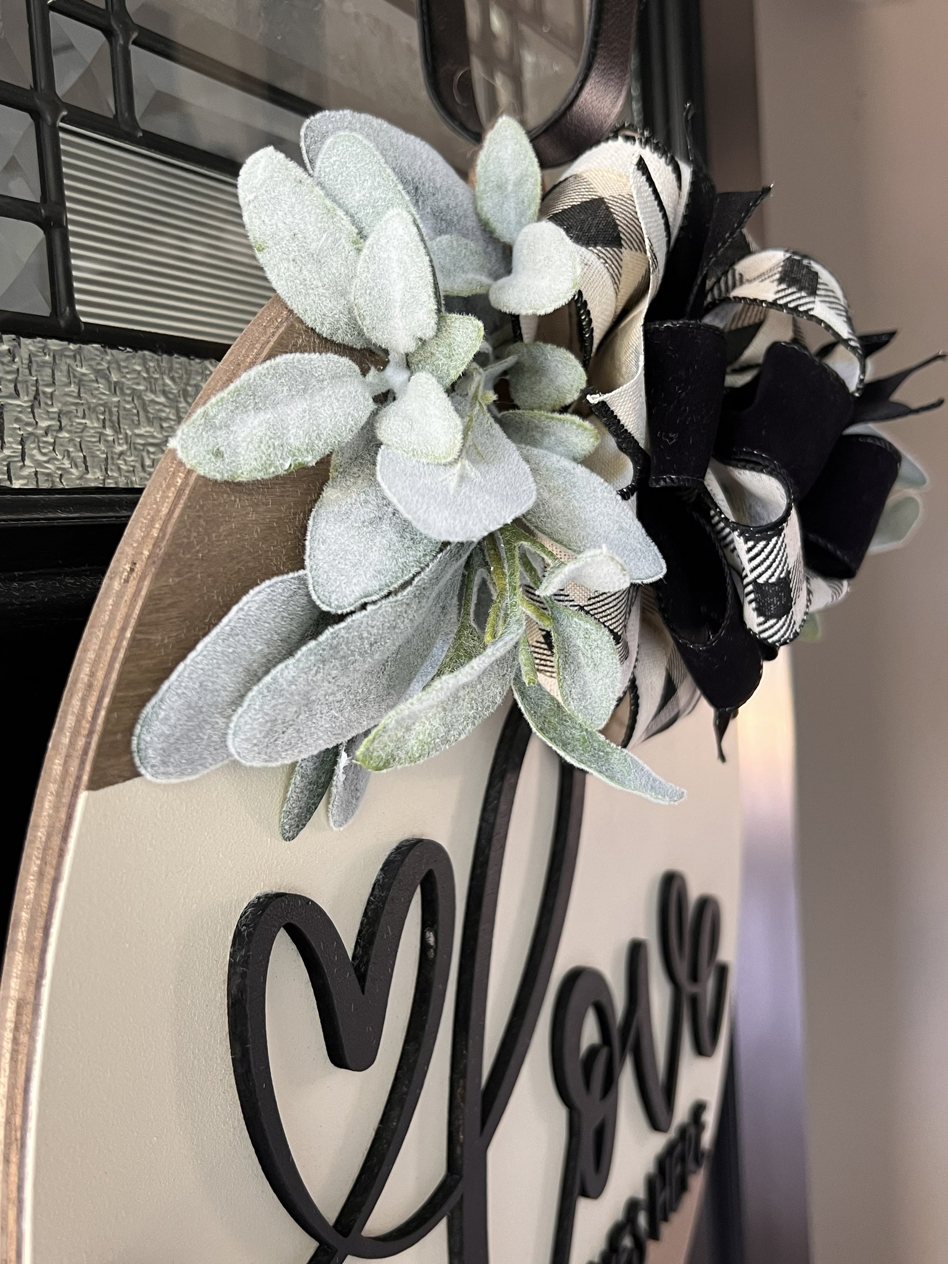 neutral home decor door hanger with greenery bow