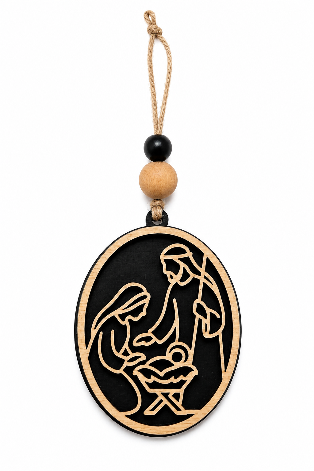 Black stain nativity ornament on cozy Christmas styled backdrop with candle and greenery