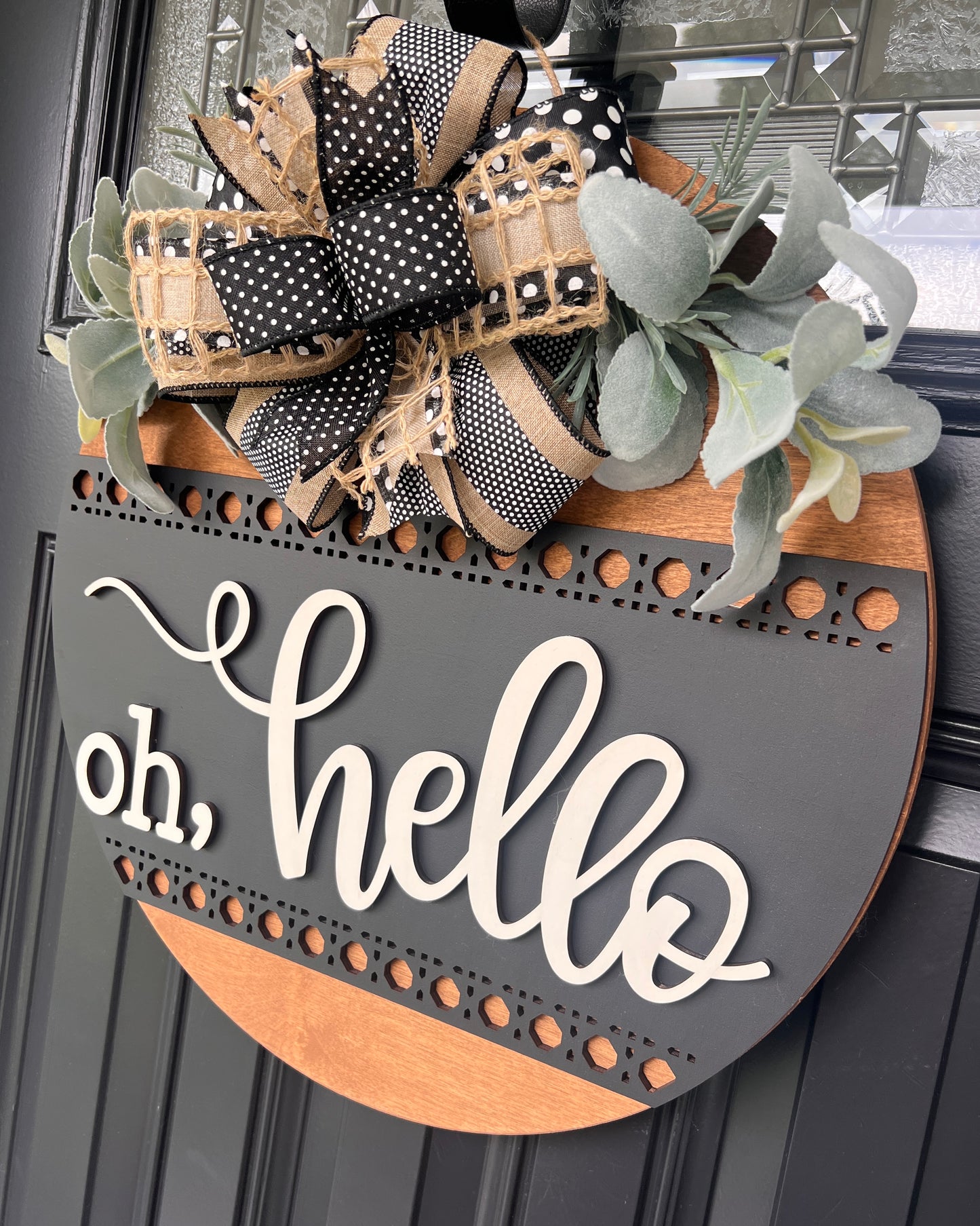 Angled view showing layered wood construction and precision laser-cut border details.
Detail of handcrafted designer bow made with premium black, cream, and burlap ribbons.
