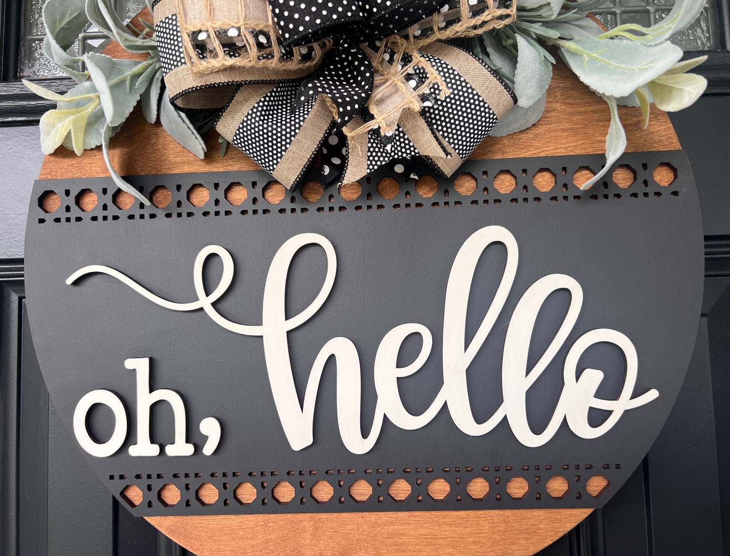 Oh hello door hanger close up showing lower rattan dot border band and bottom natural wood panel detail