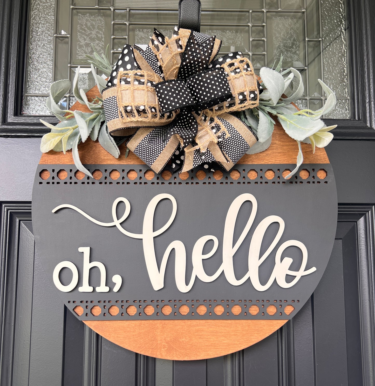 Oh hello door hanger close up showing 3D cream oh hello lettering and upper laser-cut rattan dot border band detail