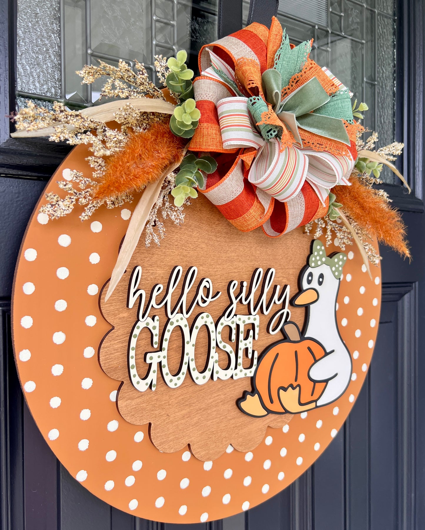 Polka dot fall Hello Silly Goose door hanger with orange bow and dried botanicals - angled view