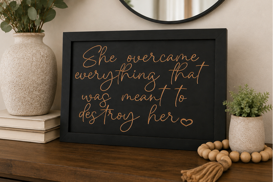 She Overcame Everything wood sign displayed on dresser with home decor