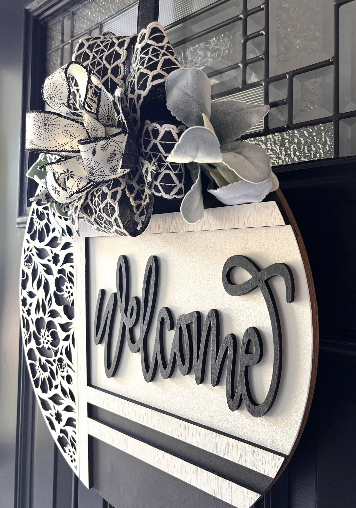 black and white welcome door hanger with floral cutout design
