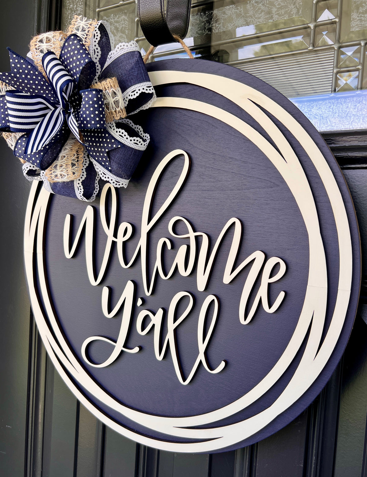Welcome Y'all 18" round wooden door hanger - full sign view on black door