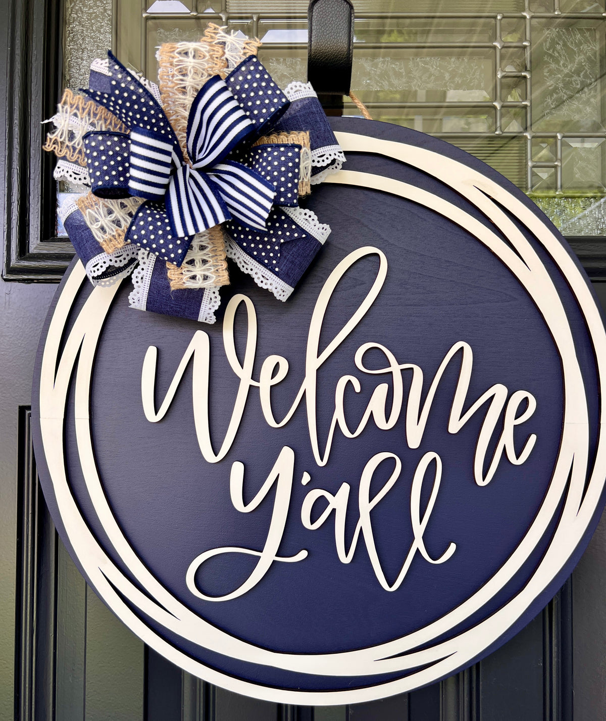 Welcome Y'all farmhouse door hanger with navy bow - side angle view