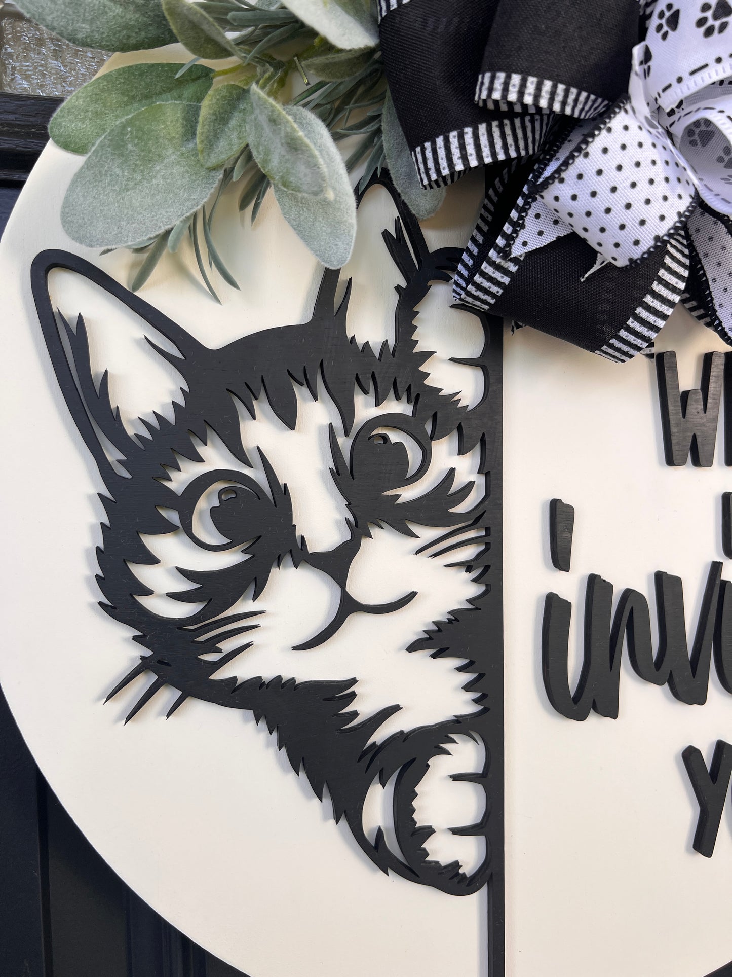 Funny cat door hanger featuring a black cat peeking around the edge and the phrase "Who Invited You?" displayed on a front door.