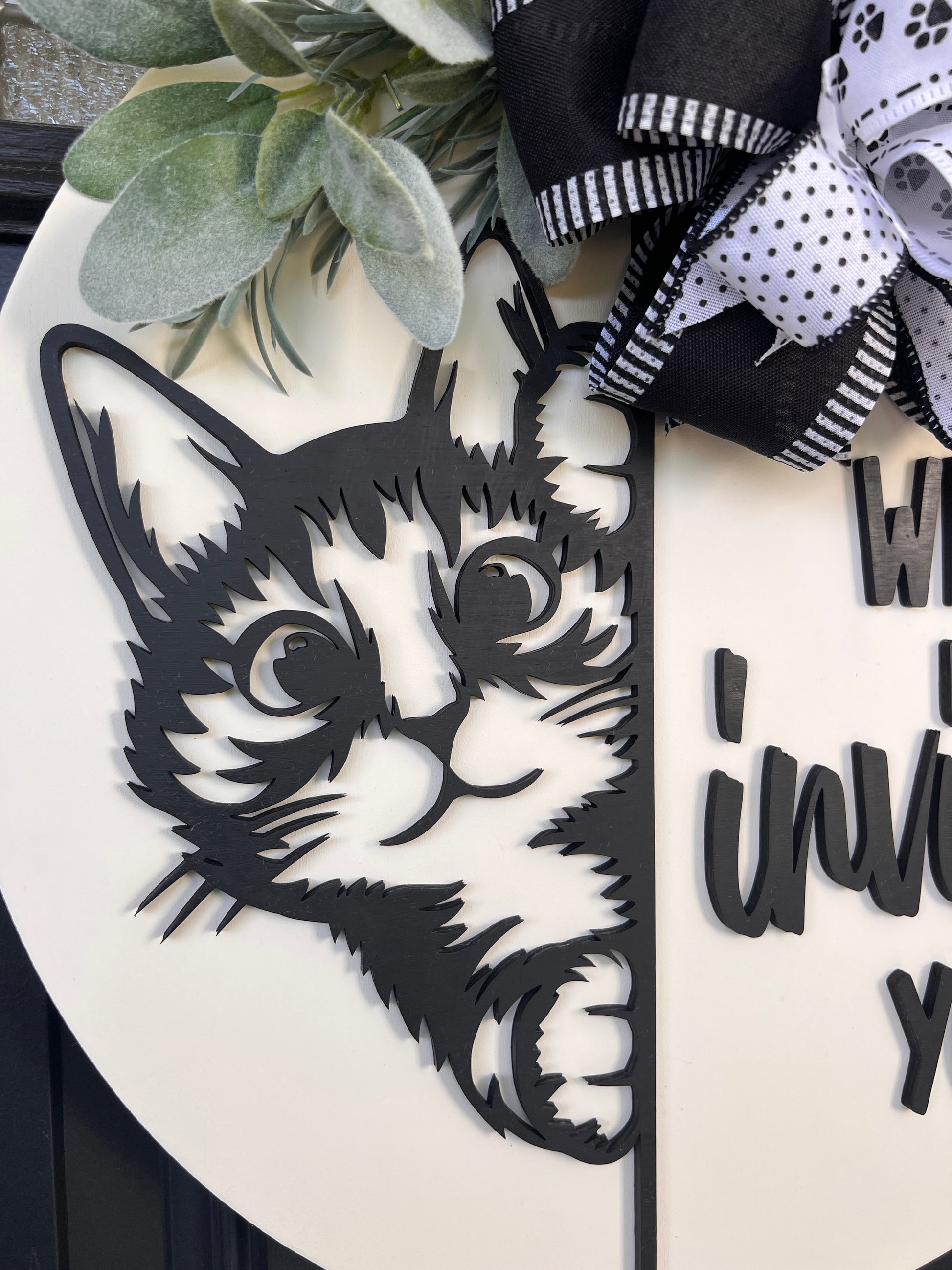 Funny cat door hanger featuring a black cat peeking around the edge and the phrase "Who Invited You?" displayed on a front door.