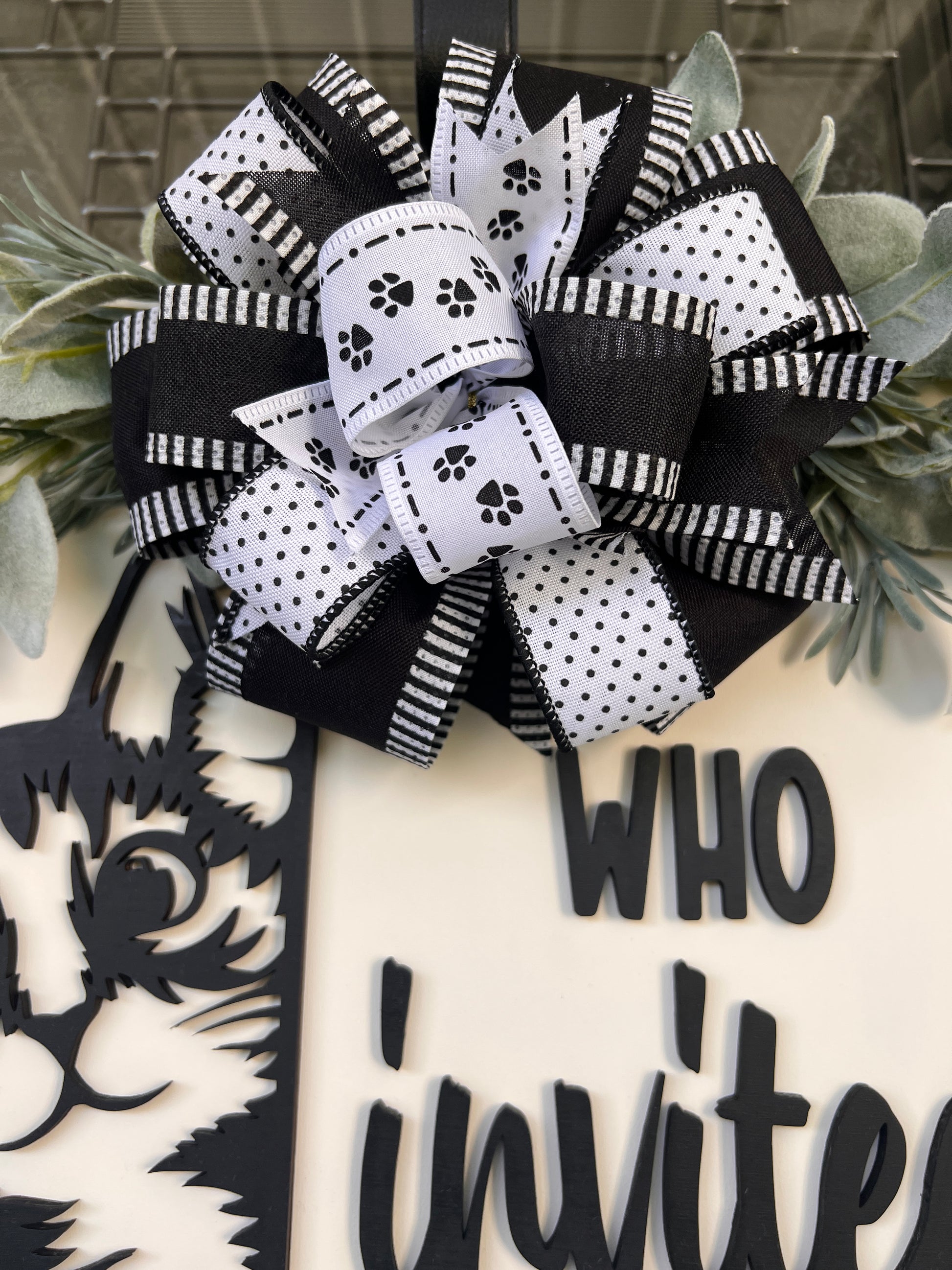 Funny cat door hanger featuring a black cat peeking around the edge and the phrase "Who Invited You?" displayed on a front door.