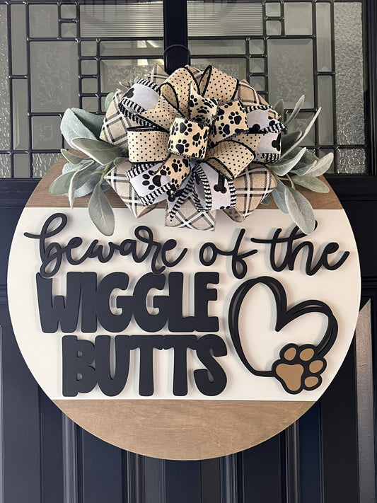 beware of the wiggle butts dog door hanger with paw print bow