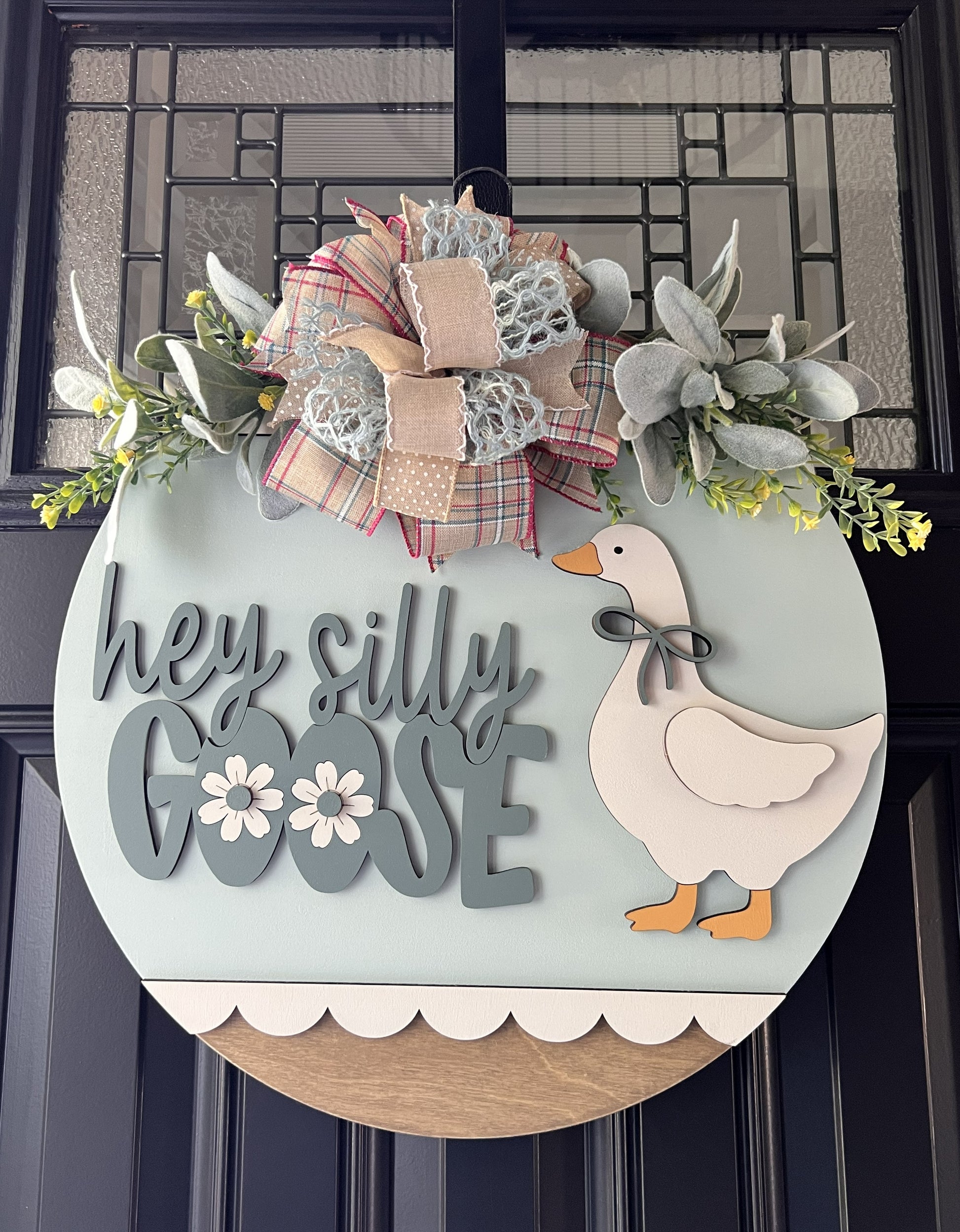 Decorative door hanger with a goose illustration and text 'hey silly goose' on a light blue background.