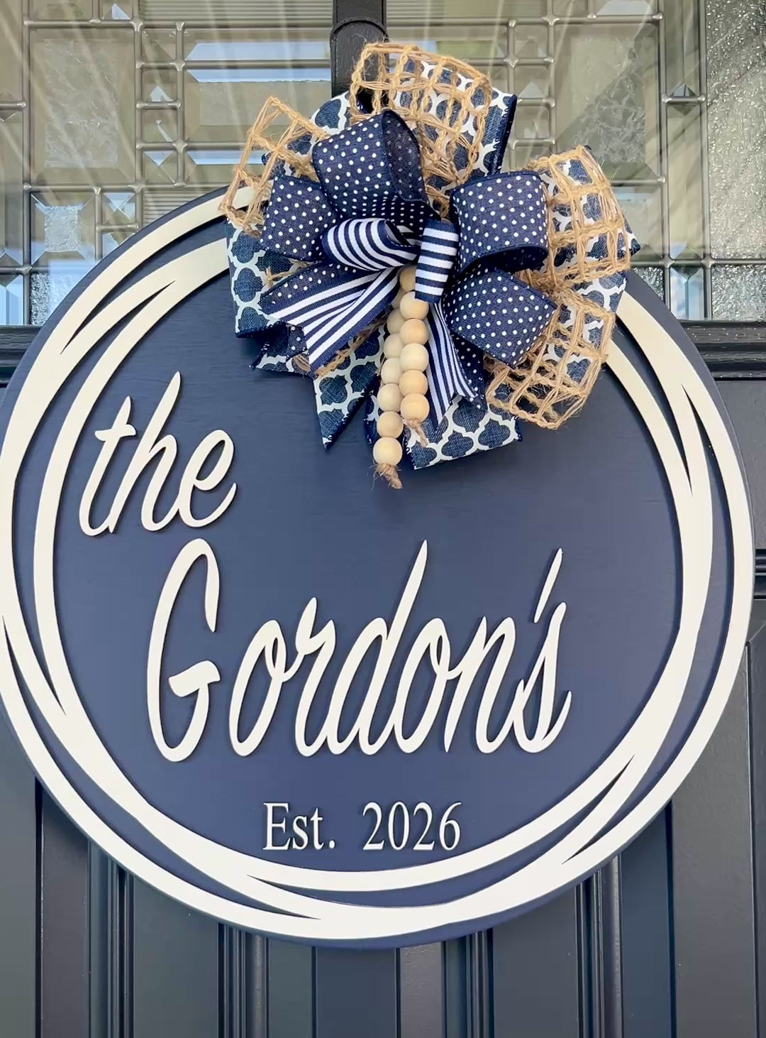 Round family name door hanger customized with last name and established date.